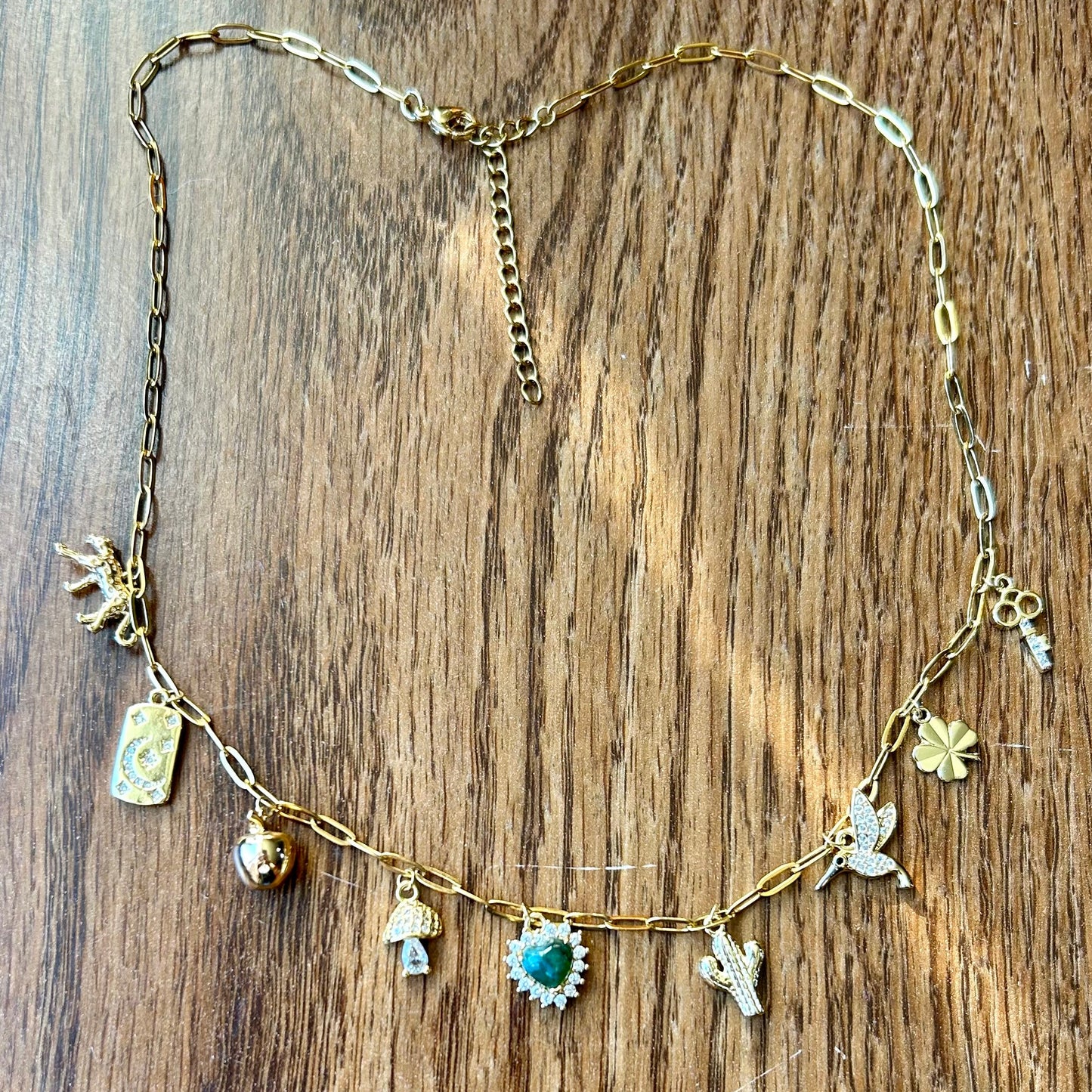 Necklace with various charms on a wooden surface