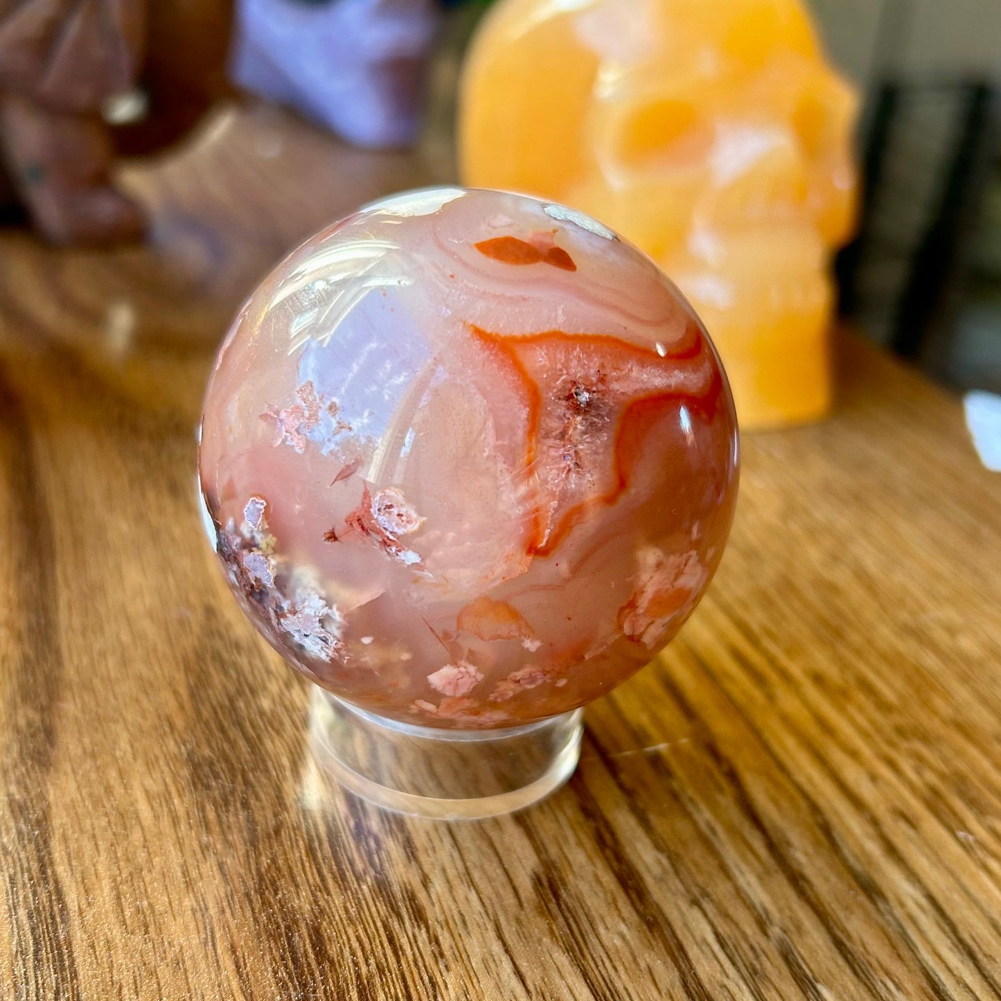 Decorative sphere on a wooden surface with blurred background
