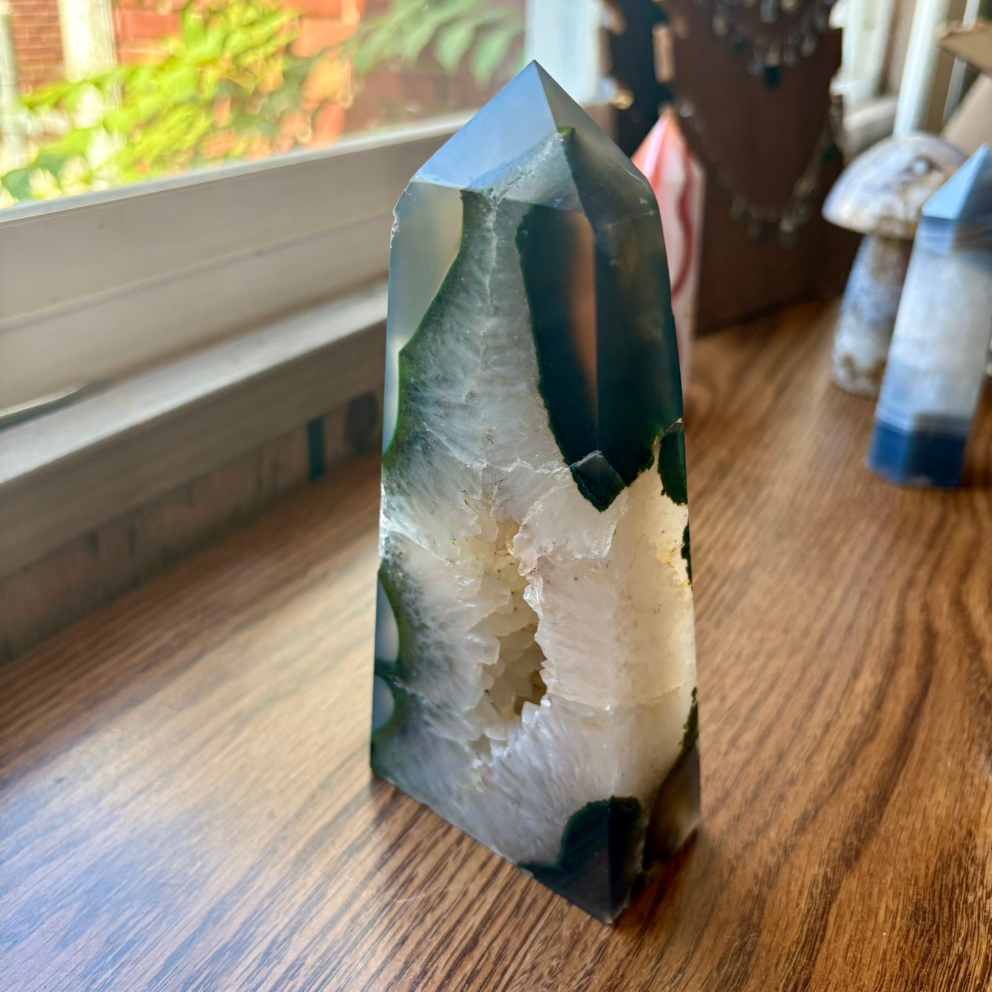 Crystal on a wooden surface with a window in the background