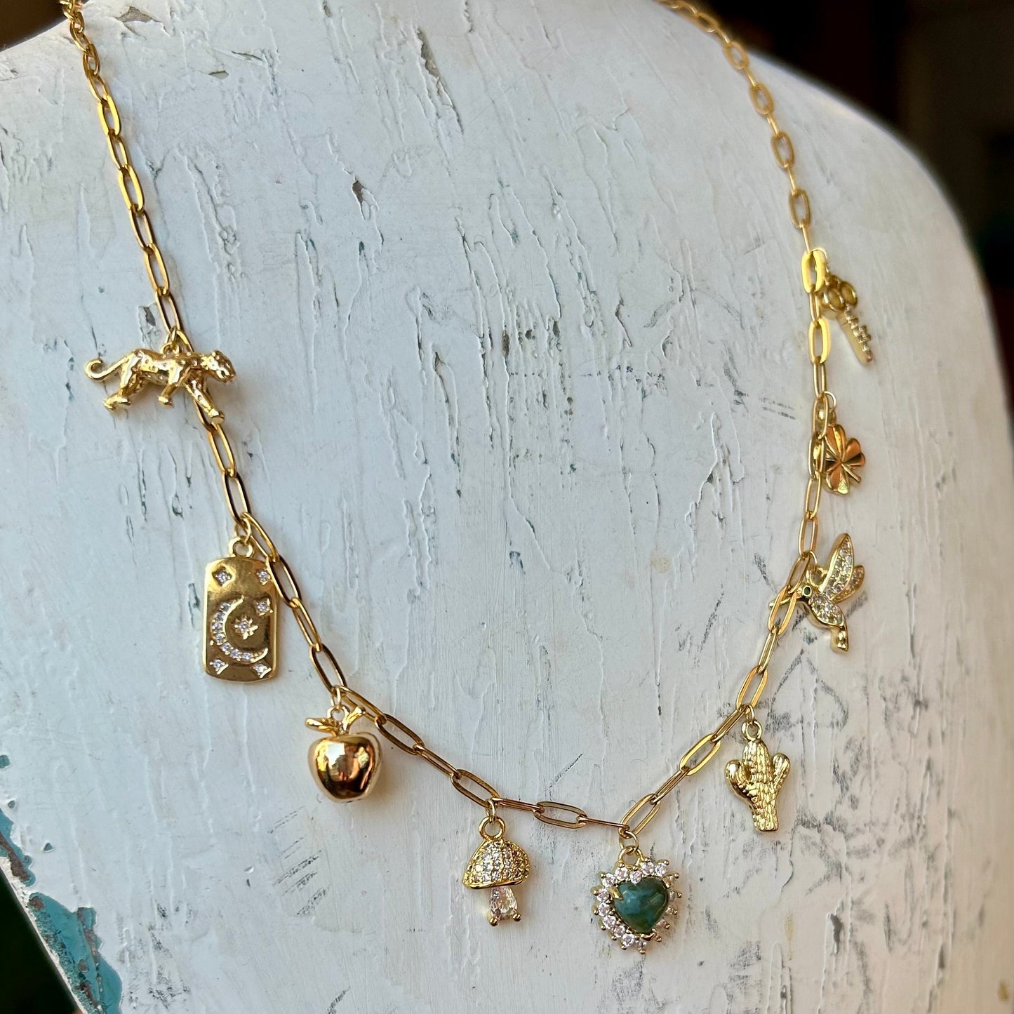 Gold necklace with heart pendant on a white mannequin bust