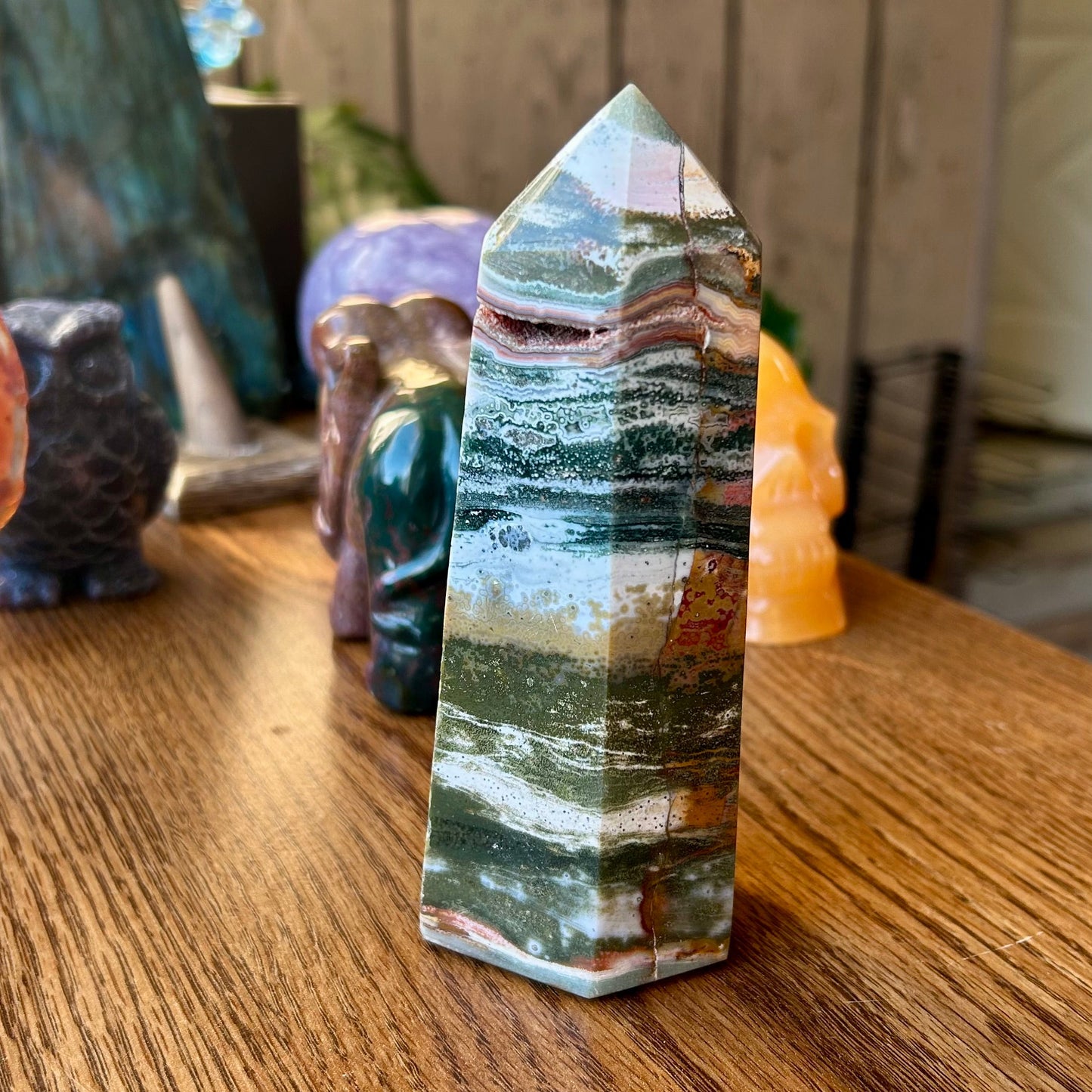Crystal tower on a wooden surface with a blurred background