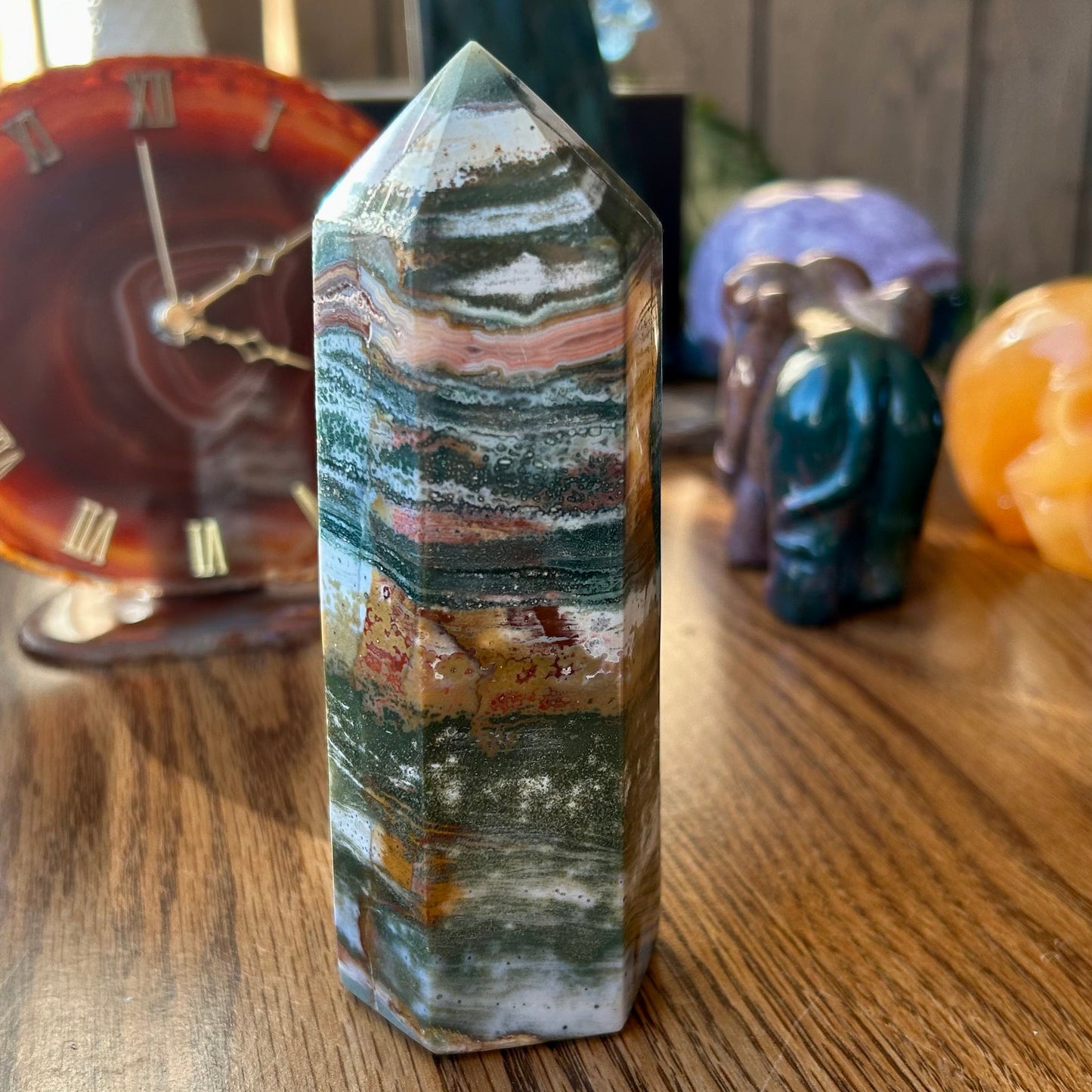 Crystal tower on a wooden surface with other crystals in the background