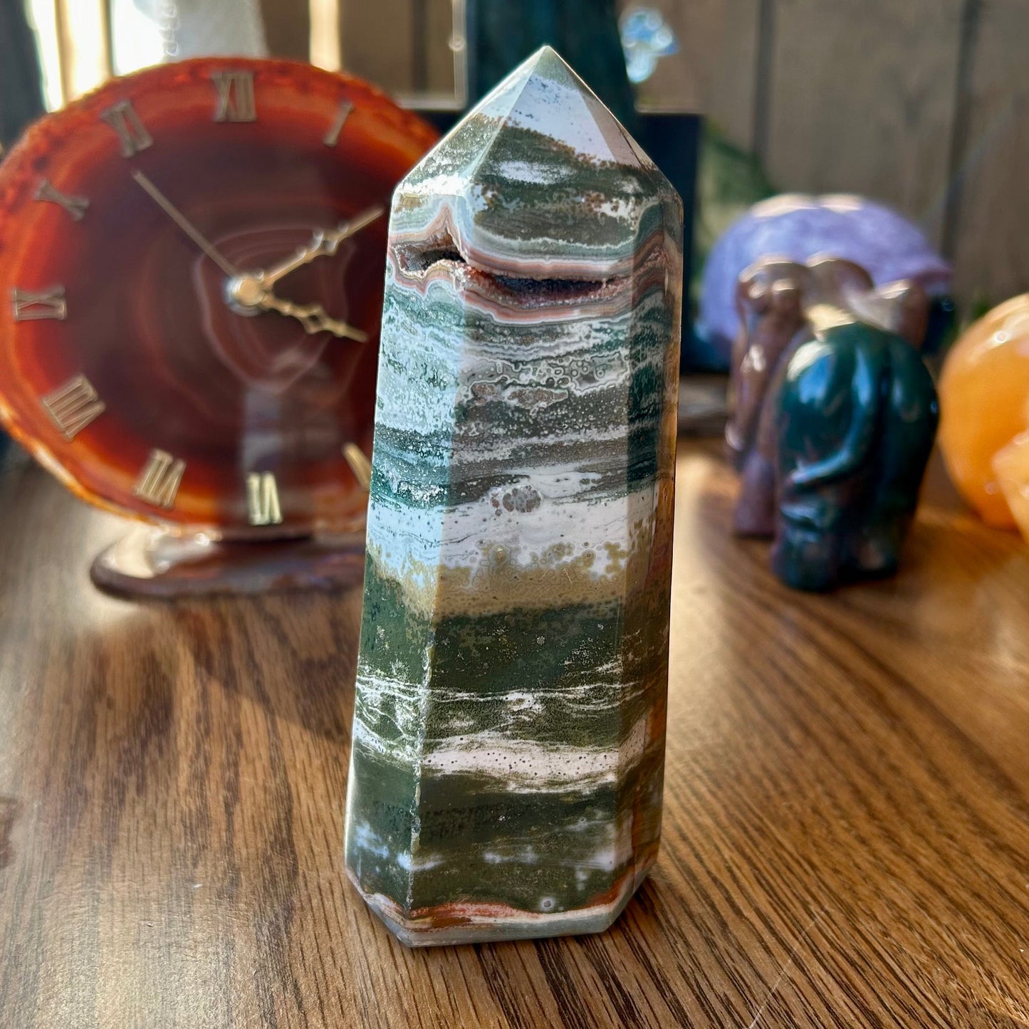Crystal tower on a wooden surface with other crystals in the background