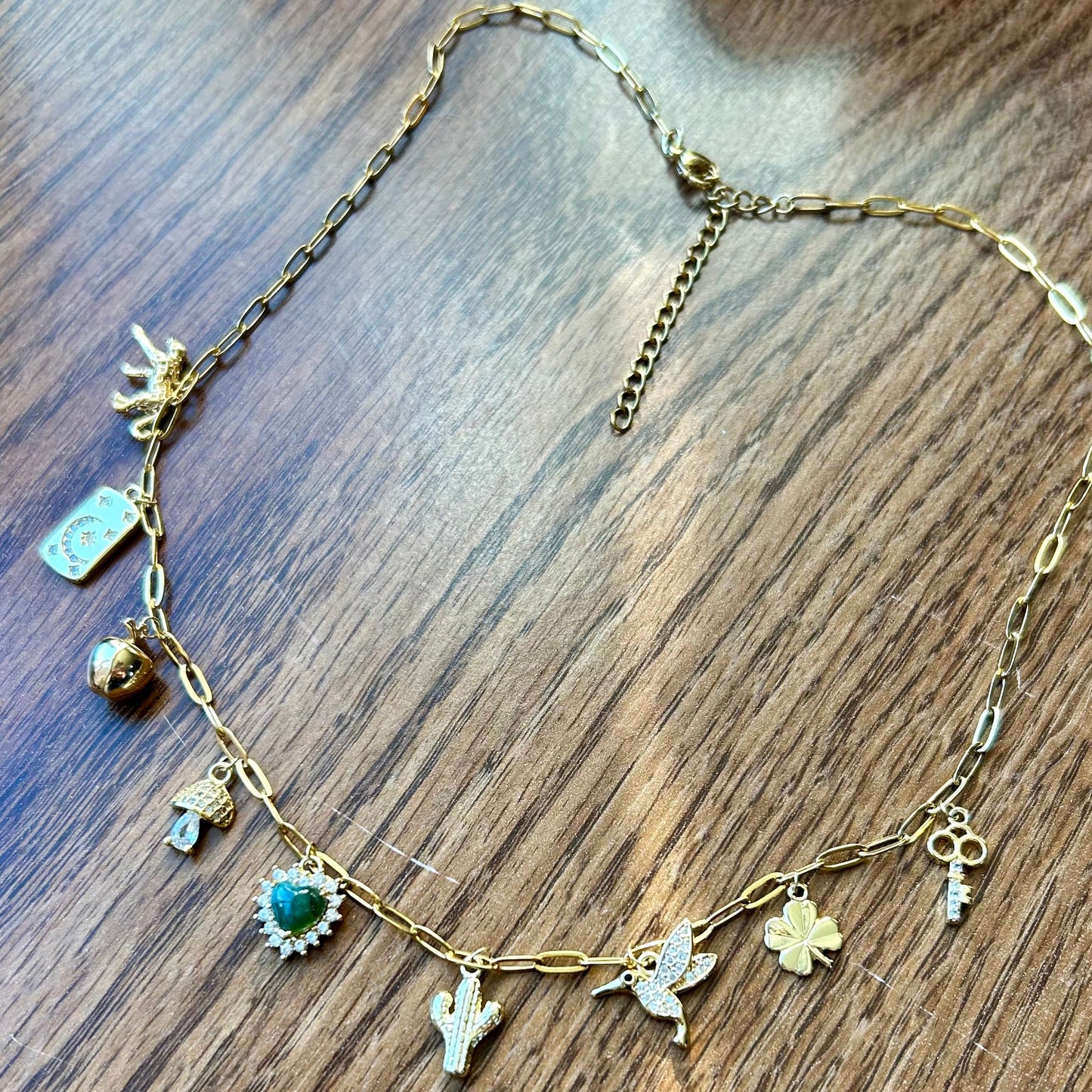 Necklace with various charms on a wooden surface