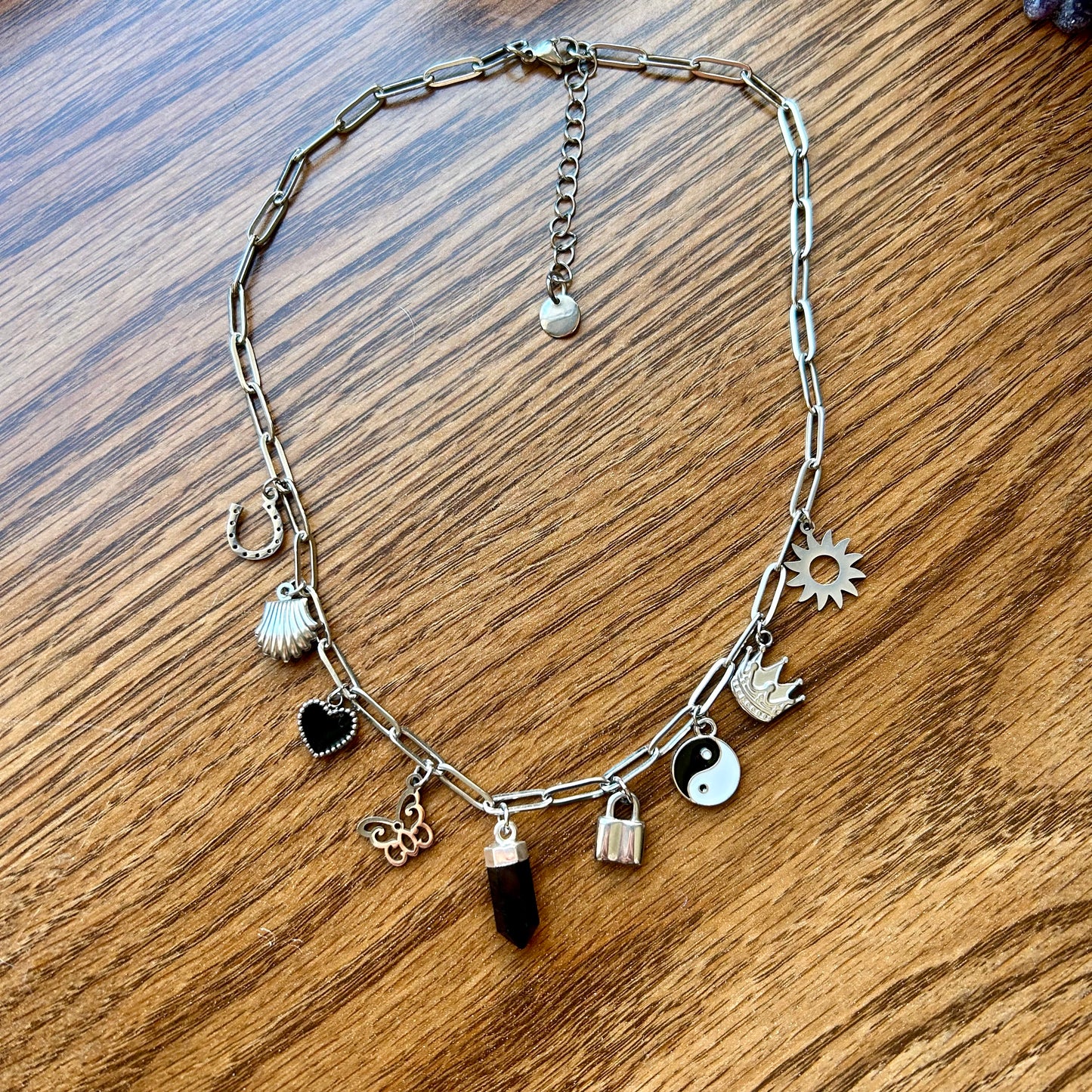 Necklace with various charms on a wooden surface