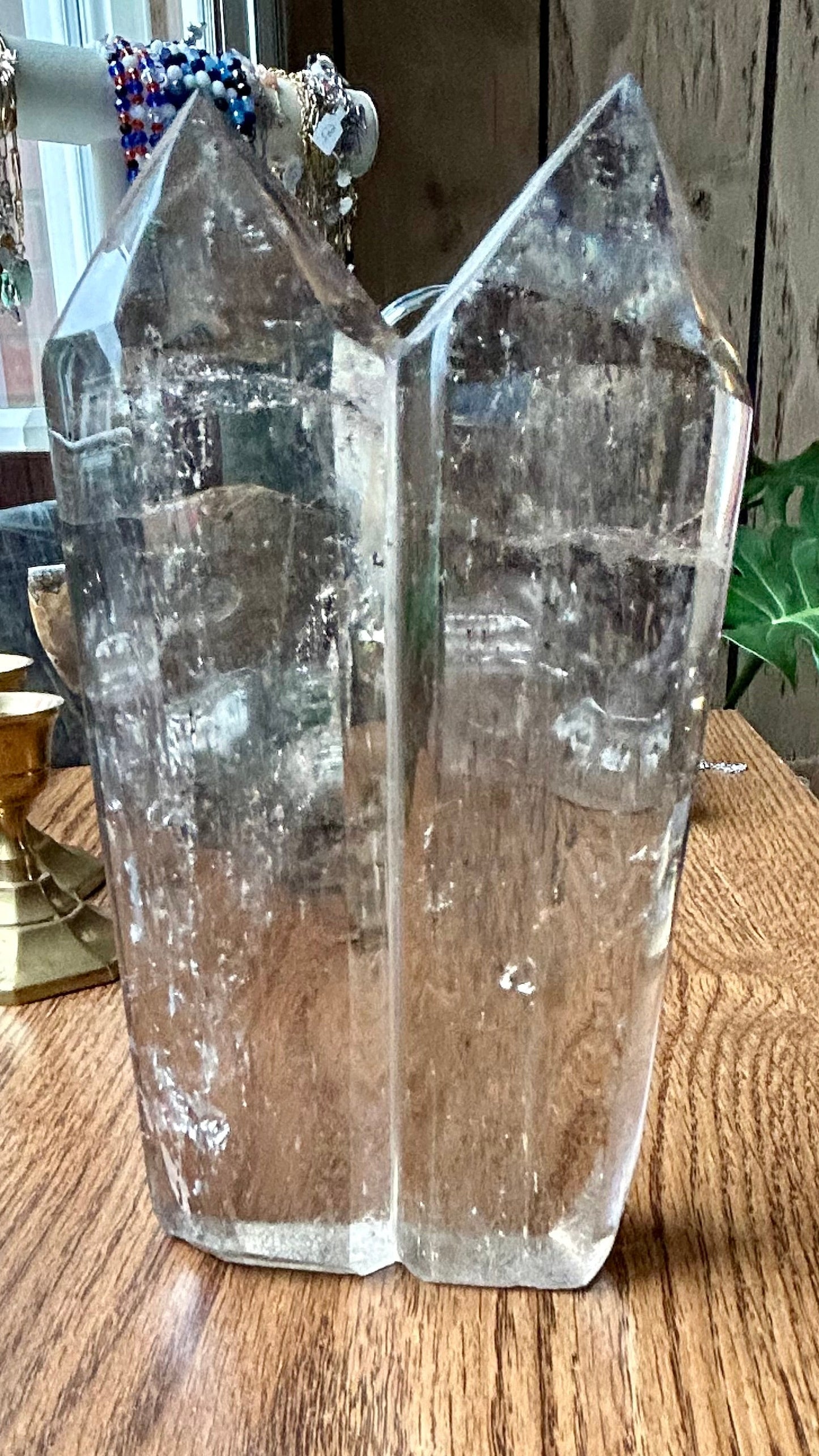 Clear crystal on a wooden surface with a blurred background