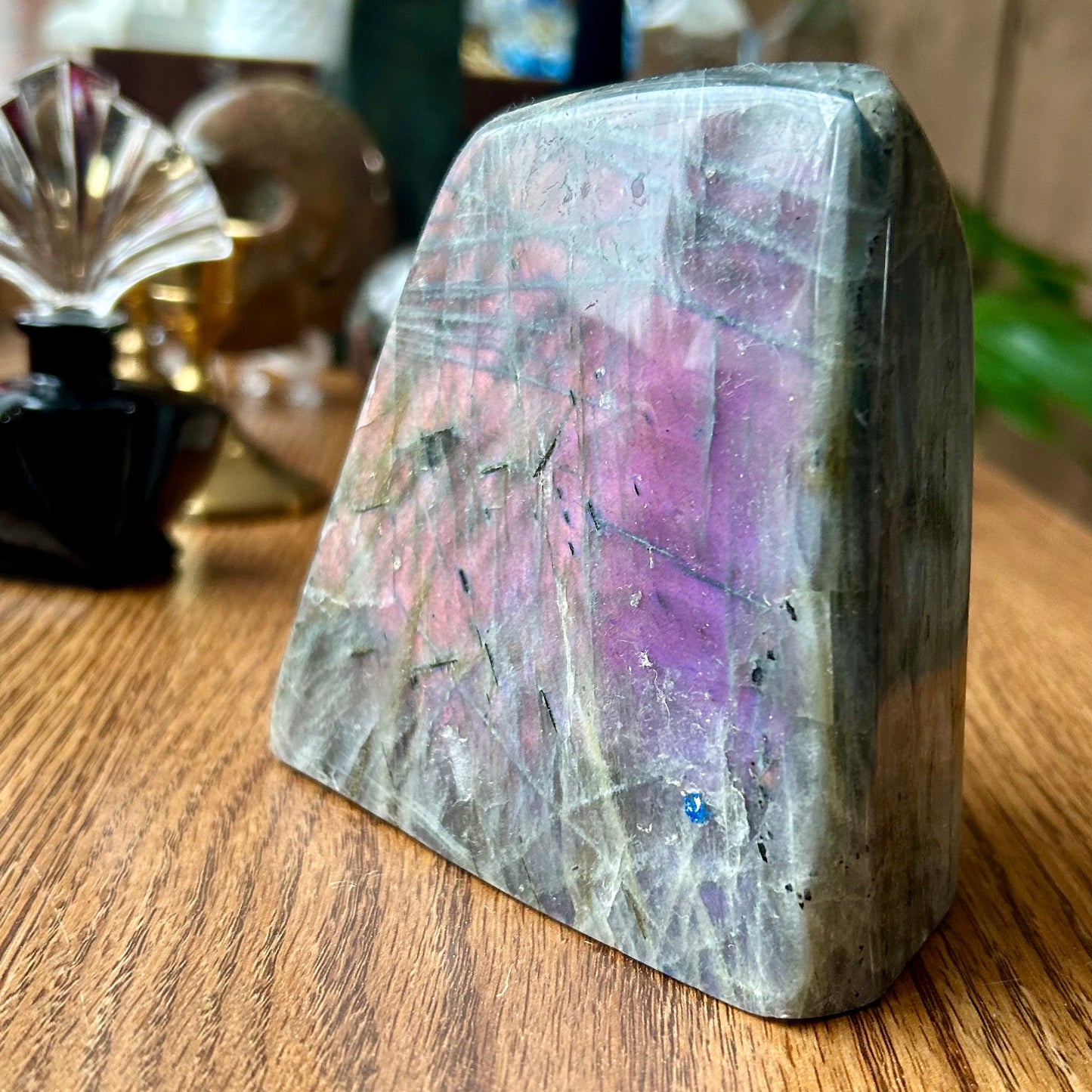 Crystal bookend with multicolored stone on a wooden surface