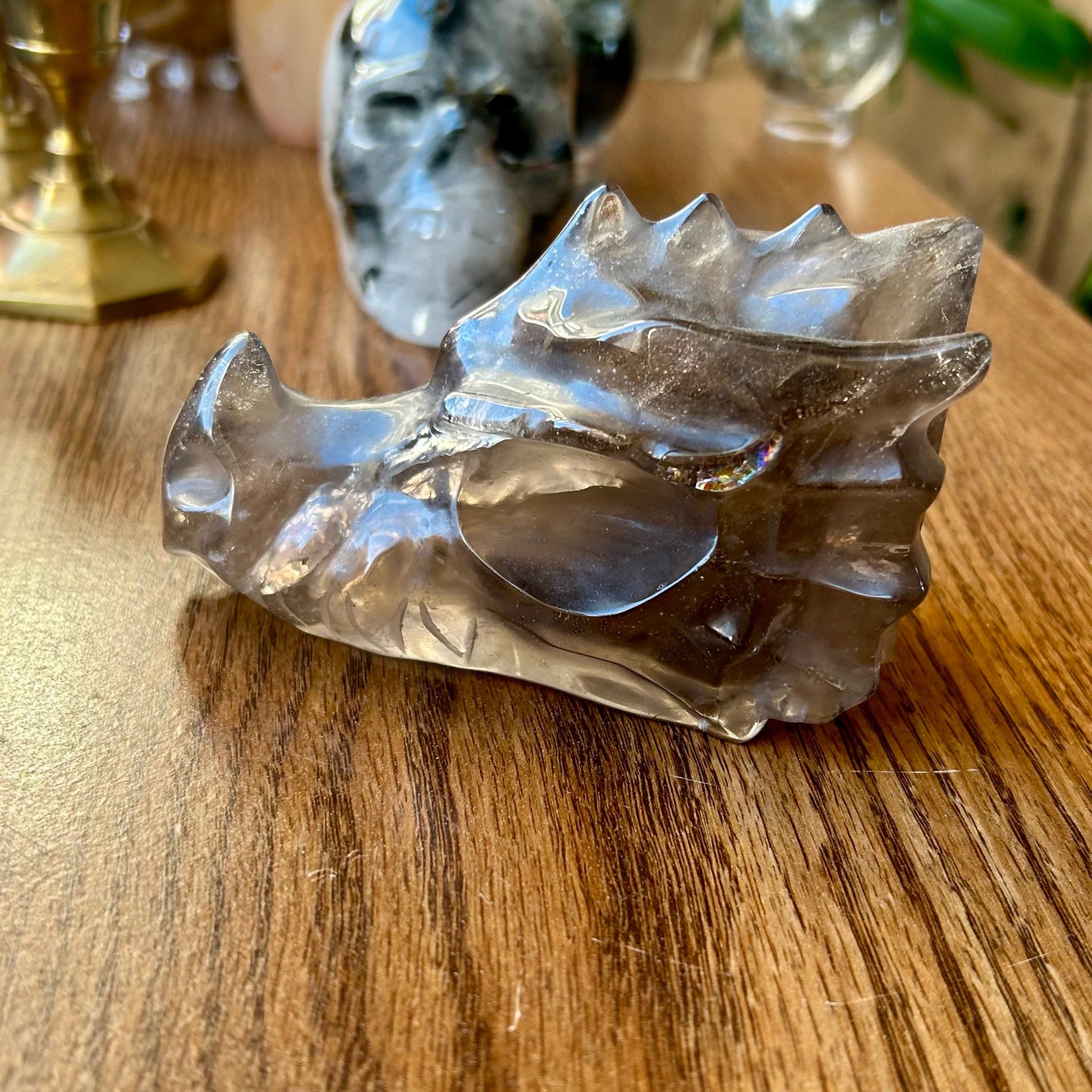 Crystal sculpture on a wooden surface with blurred background