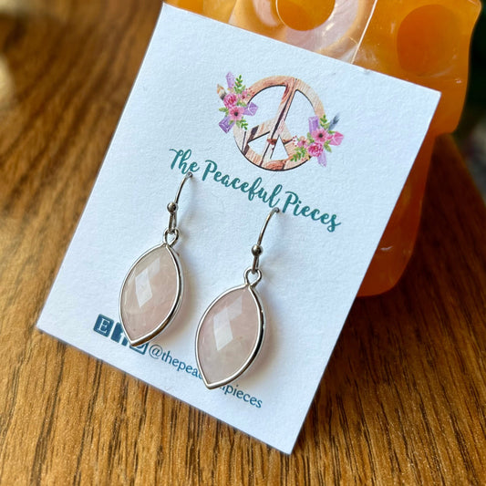 Earrings on a 'The Peaceful Pieces' branded card with a decorative 'D' logo.