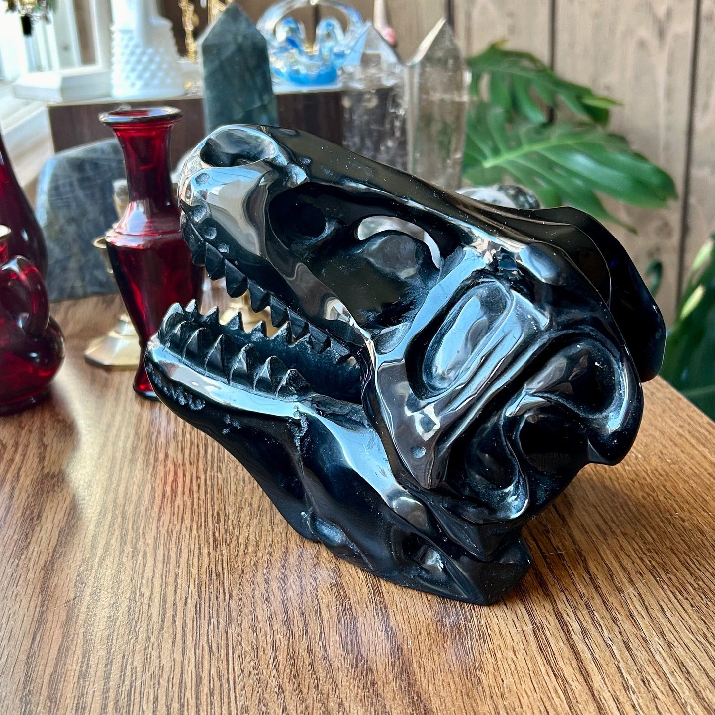 Black ceramic animal skull on a wooden surface with a blurred background