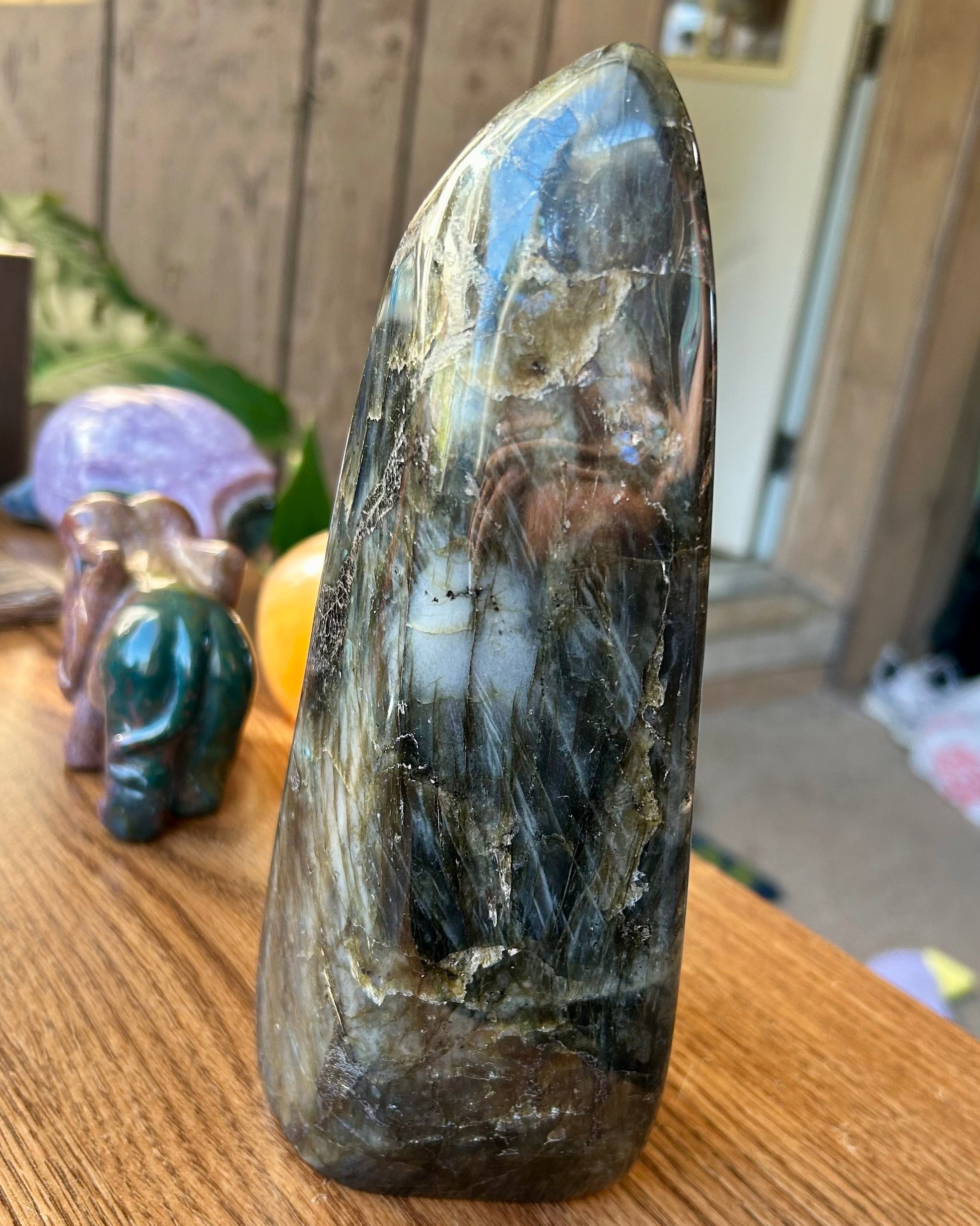 Polished crystal on a wooden surface with a blurred background