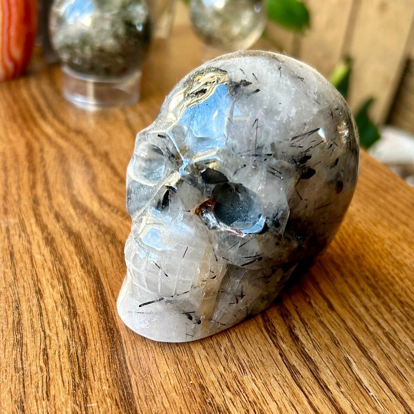 Crystal skull on a wooden surface with blurred background