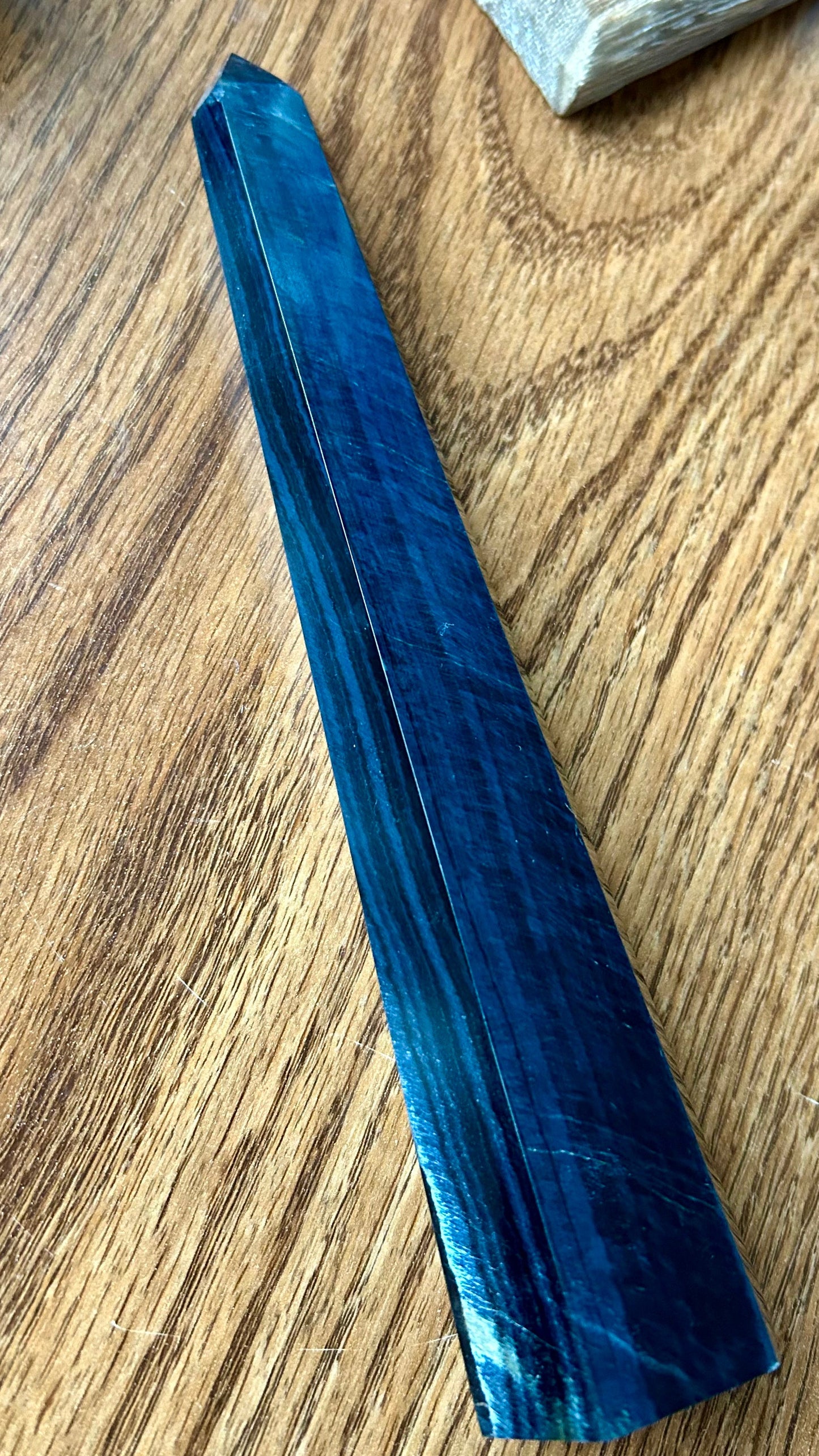 Blue crystal on a wooden surface