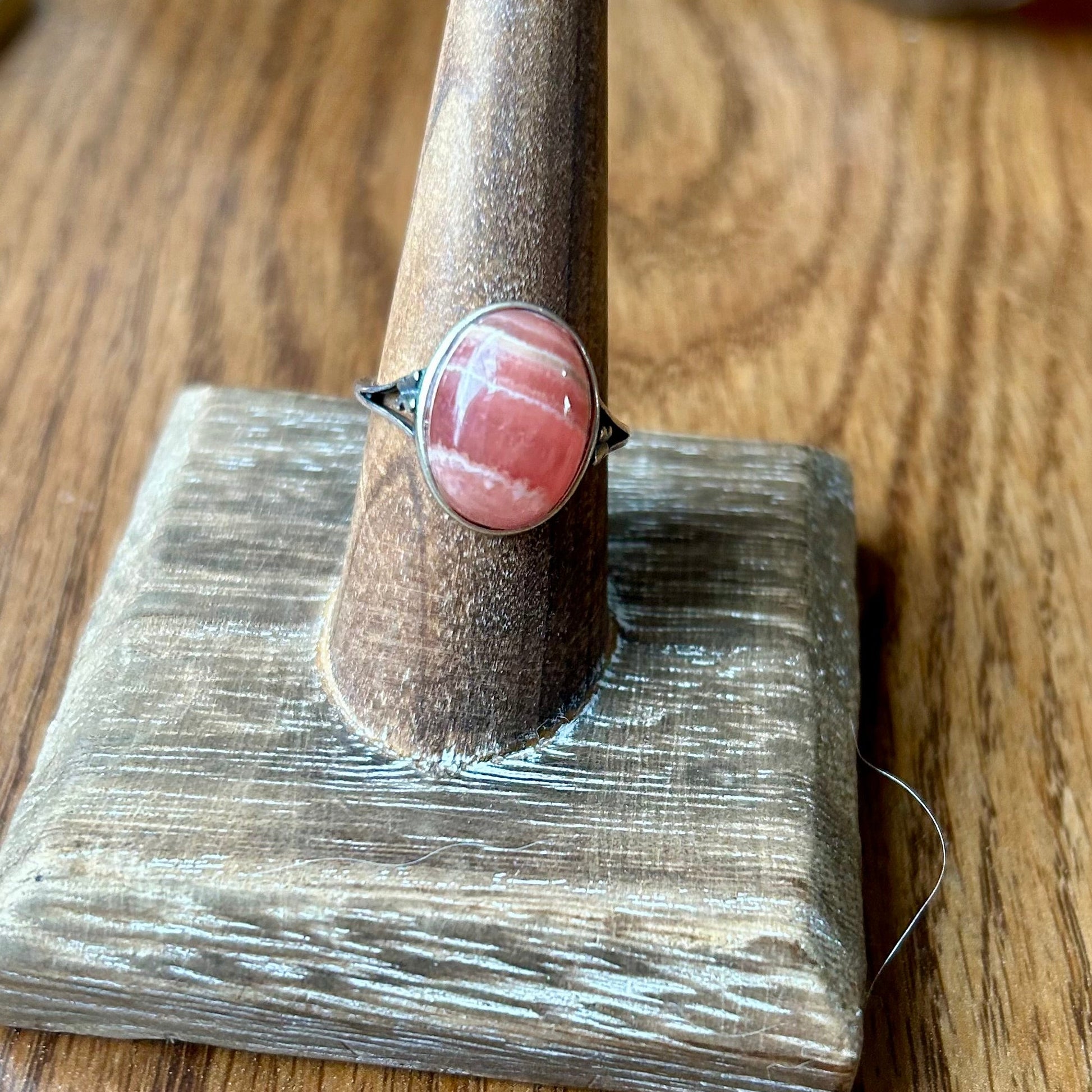 Ring on a wooden stand with a wooden surface in the background