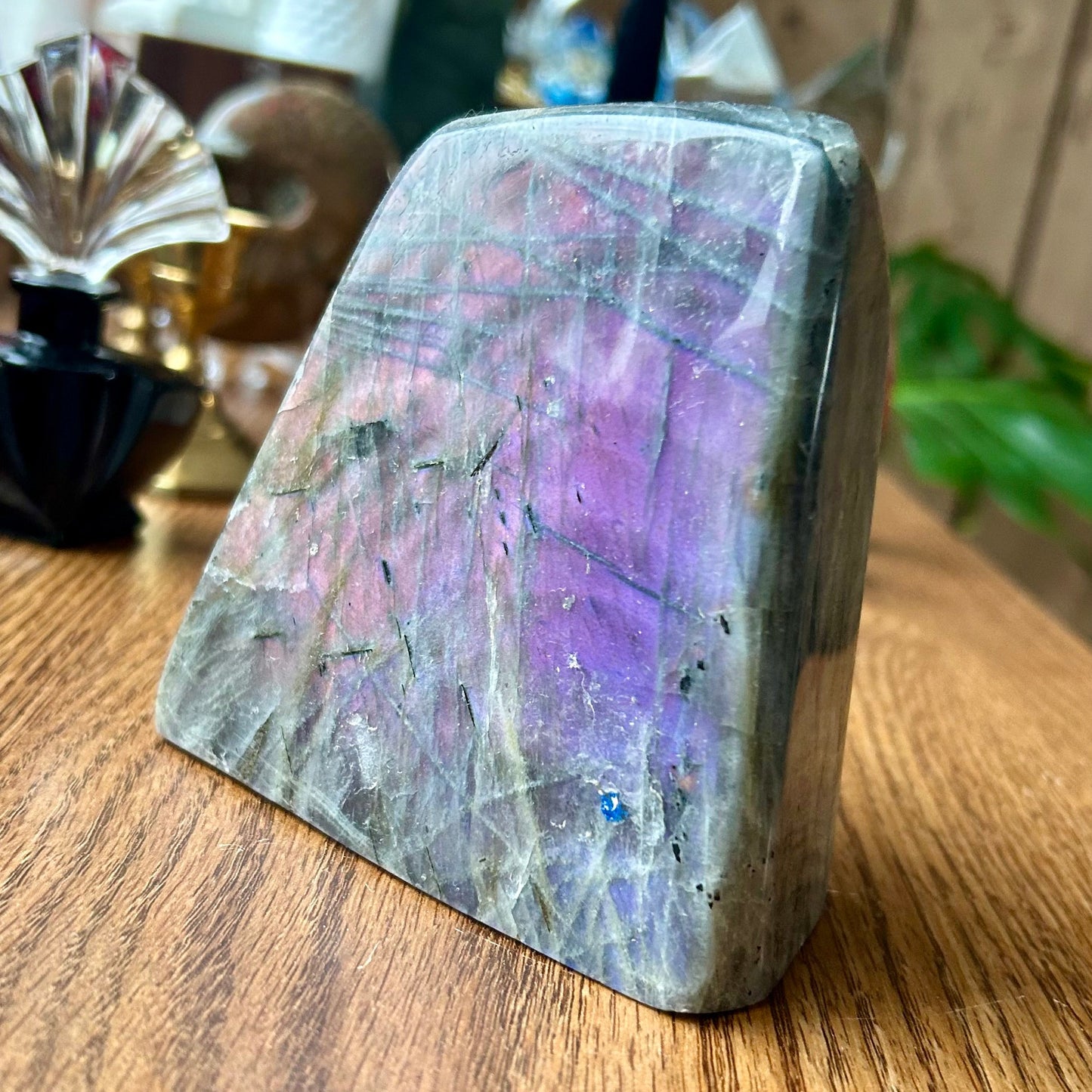 Multicolored crystal on a wooden surface with blurred background