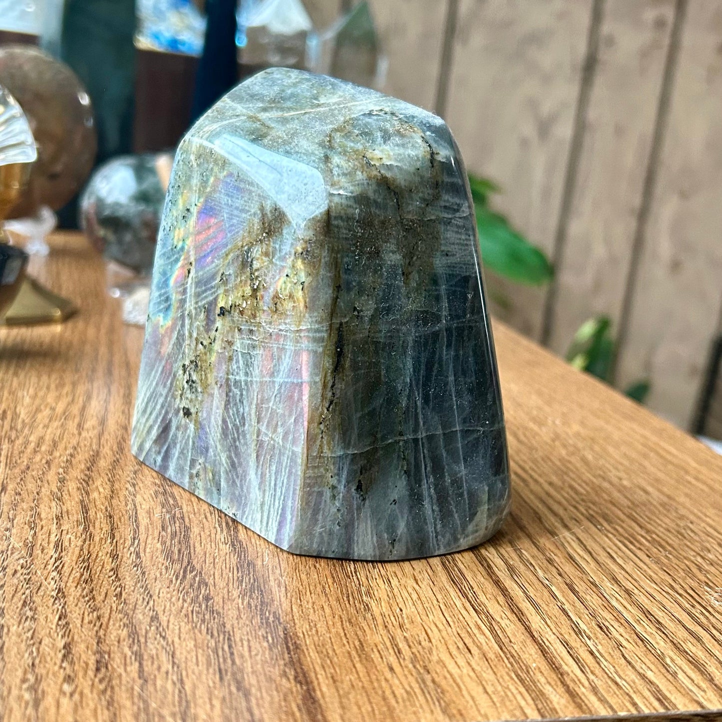 Polished crystal on a wooden surface with a blurred background