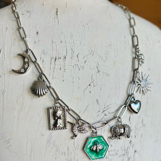 Necklace with various charms on a mannequin bust