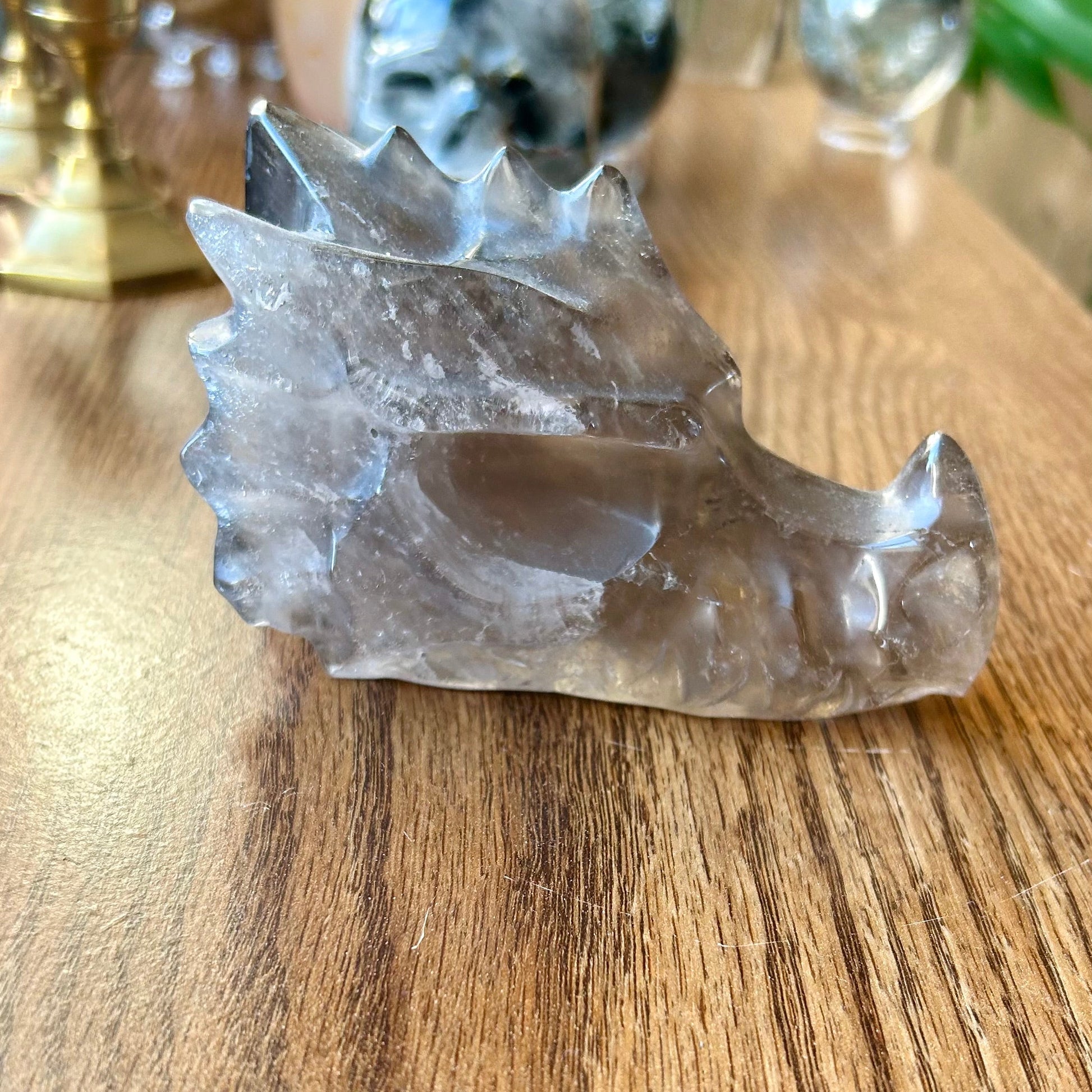 Clear crystal sculpture on a wooden surface