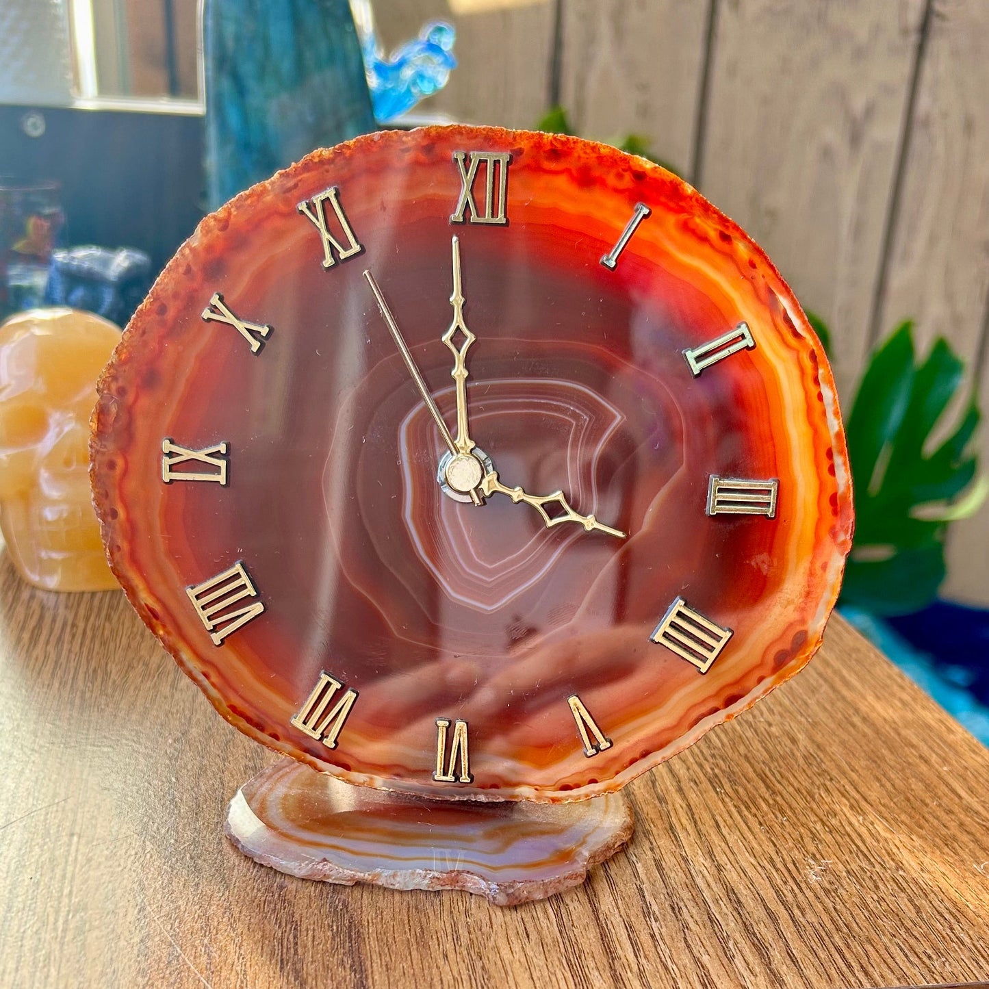 Decorative clock with agate-like design on a wooden surface