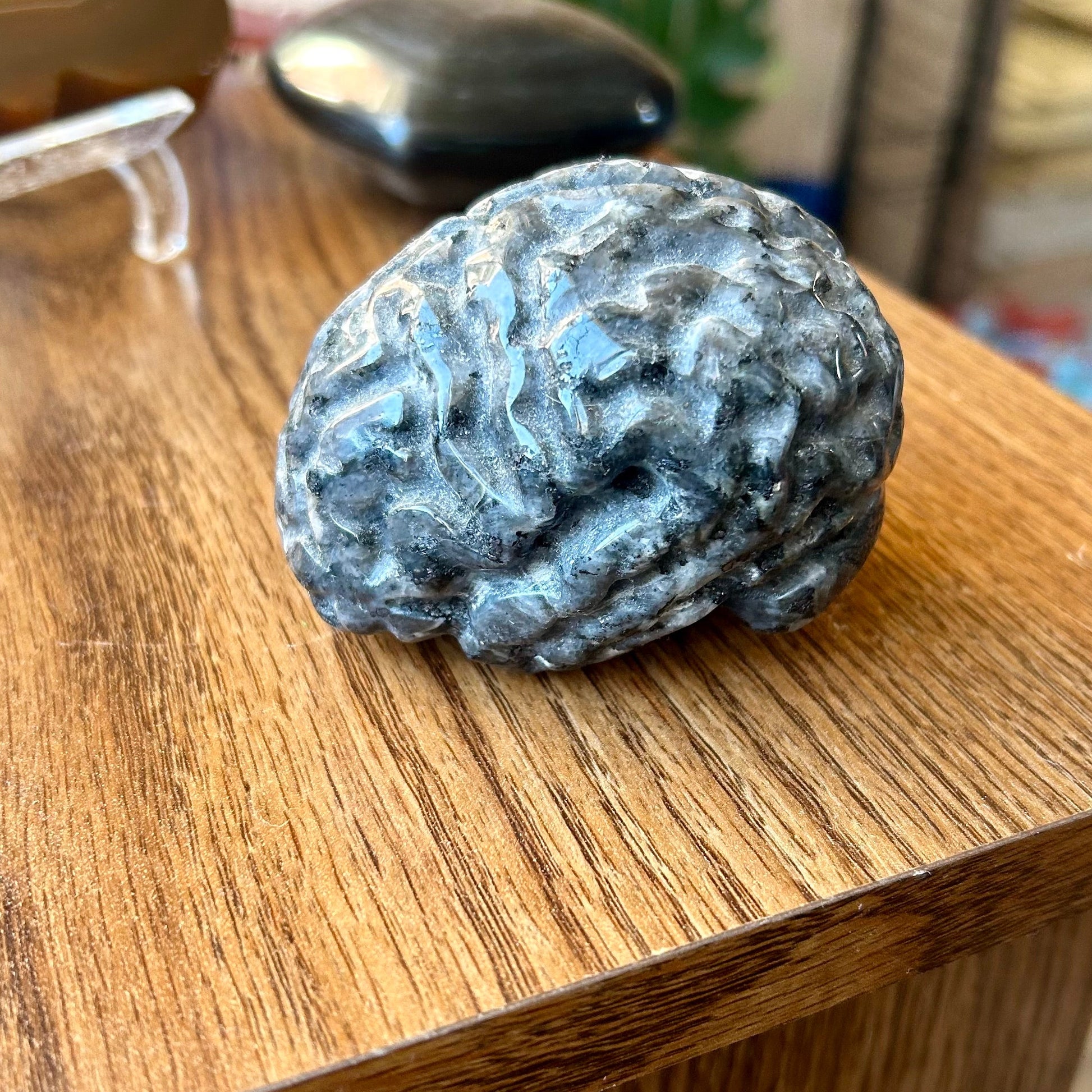 Blue and white textured stone on a wooden surface with a blurred background