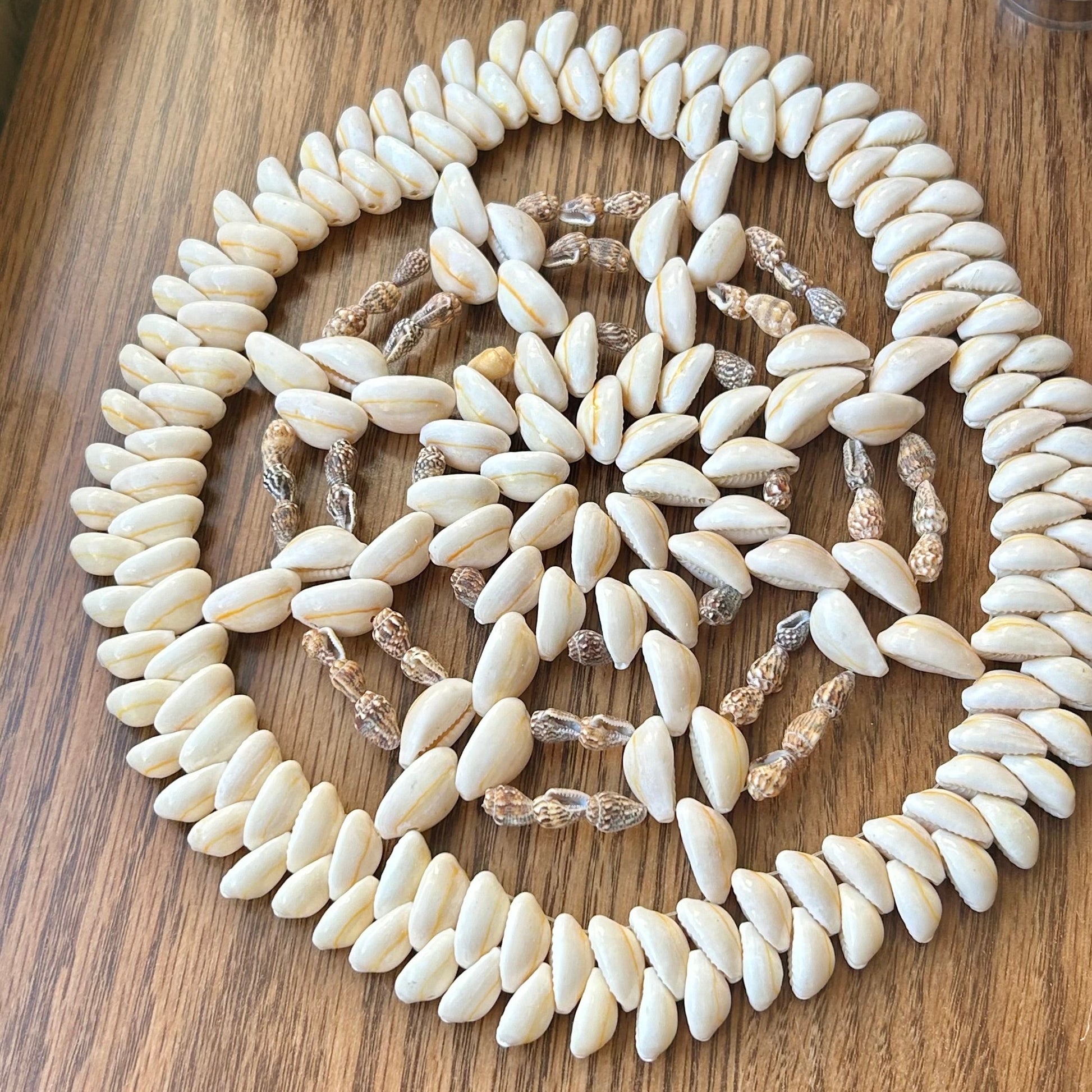 Decorative shell necklace on a wooden surface