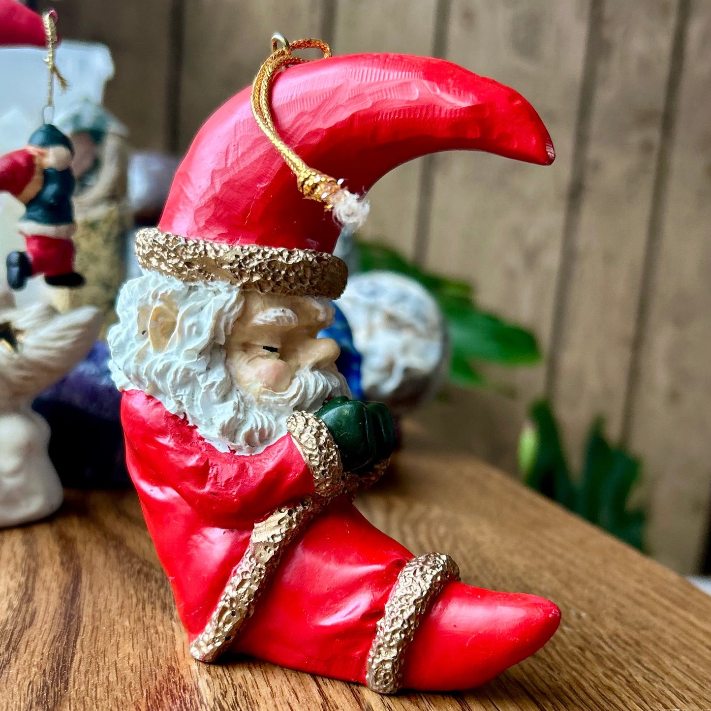 Decorative gnome figurine with a red hat and shoes on a wooden surface