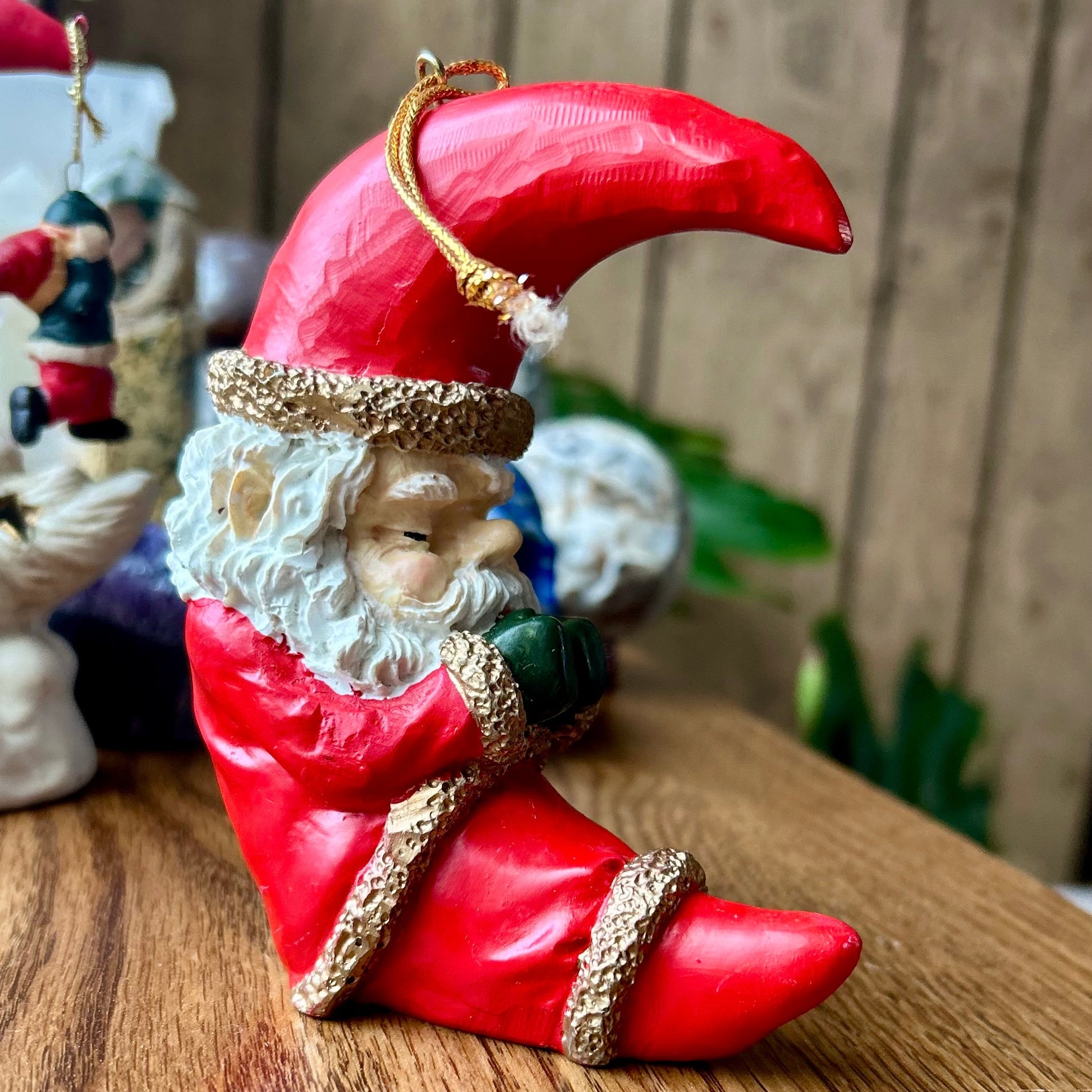 Decorative gnome figurine with a red hat and shoes on a wooden surface