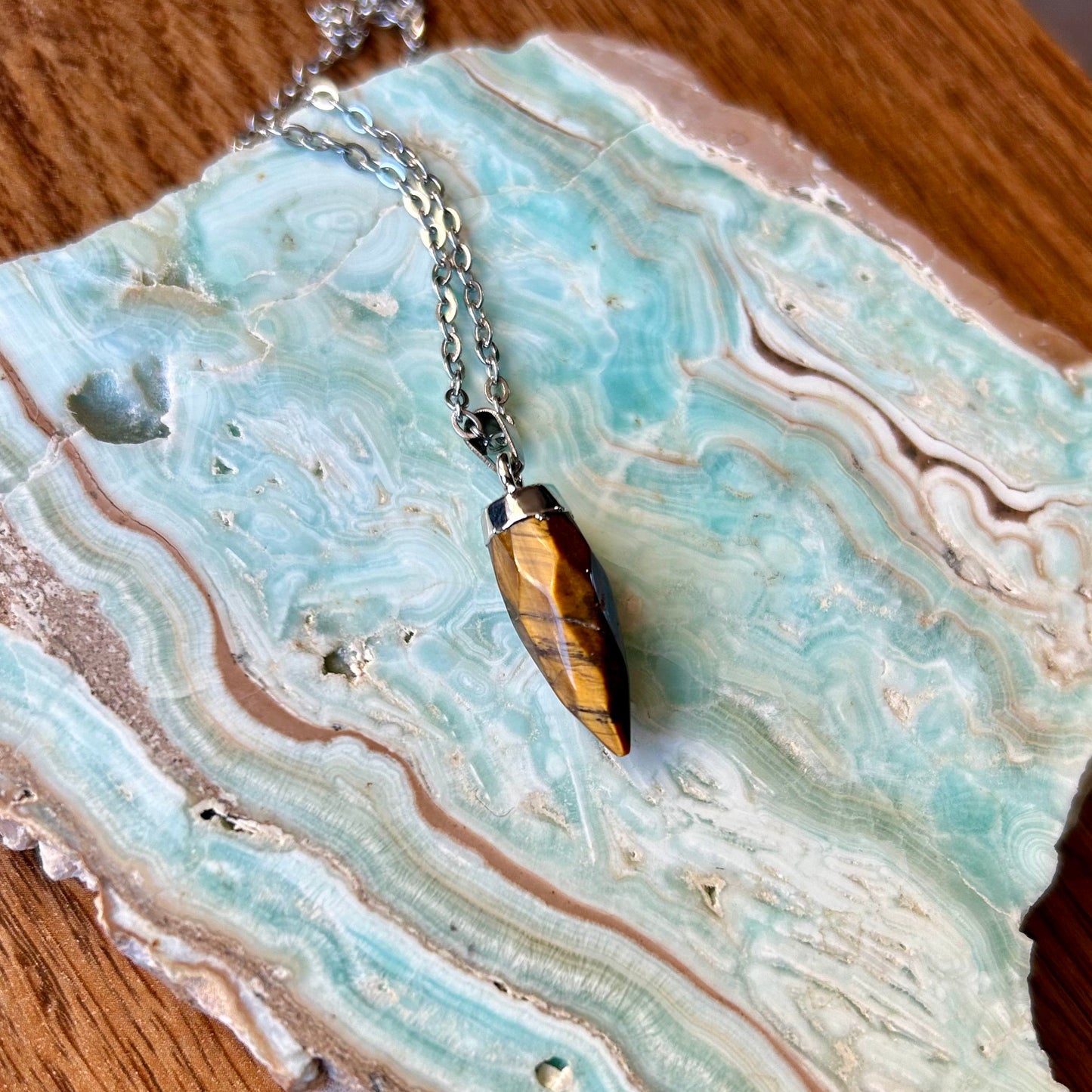 Necklace with a pendant on a decorative stone surface