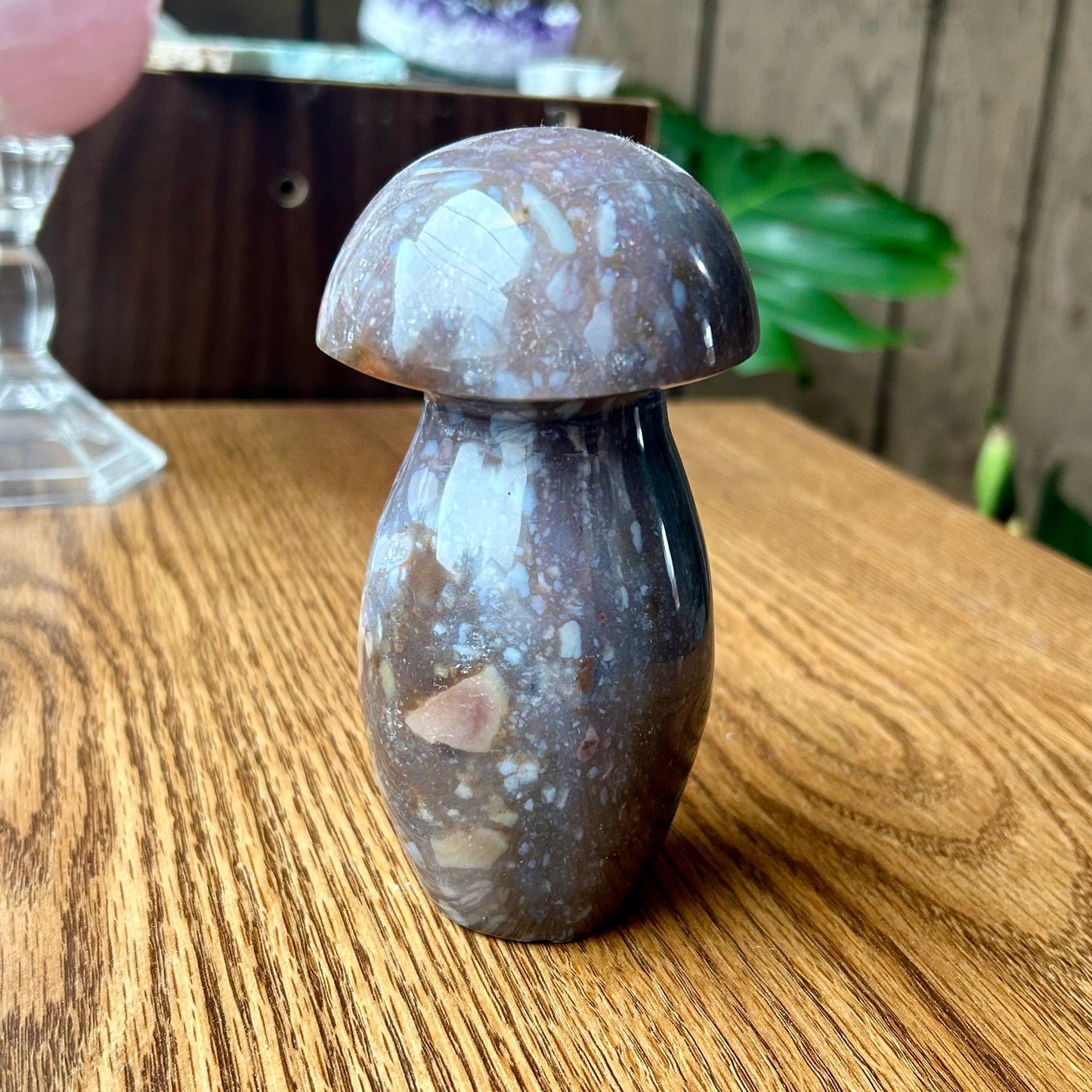 Decorative mushroom-shaped object on a wooden surface with a blurred background