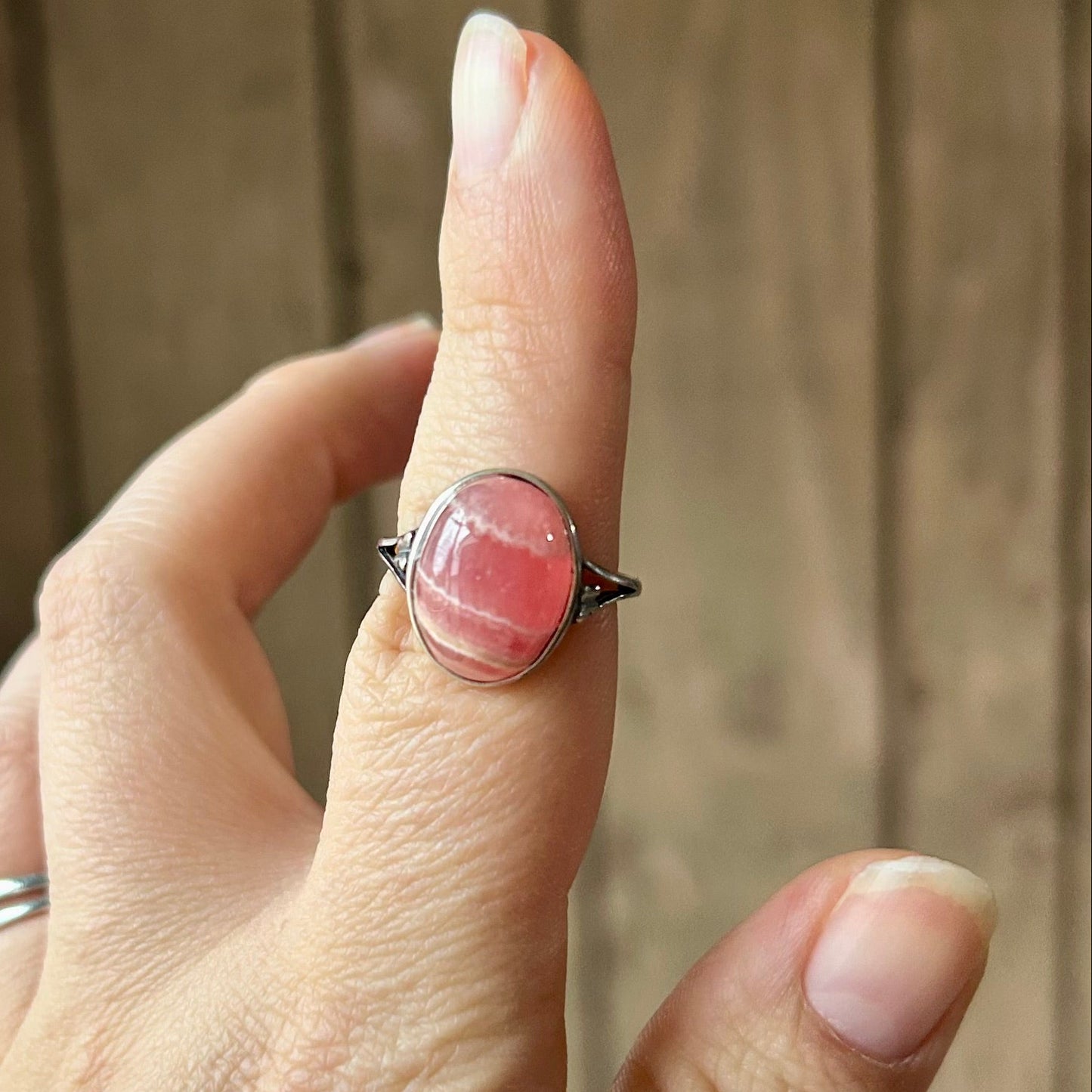 Hand with a ring on a blurred background