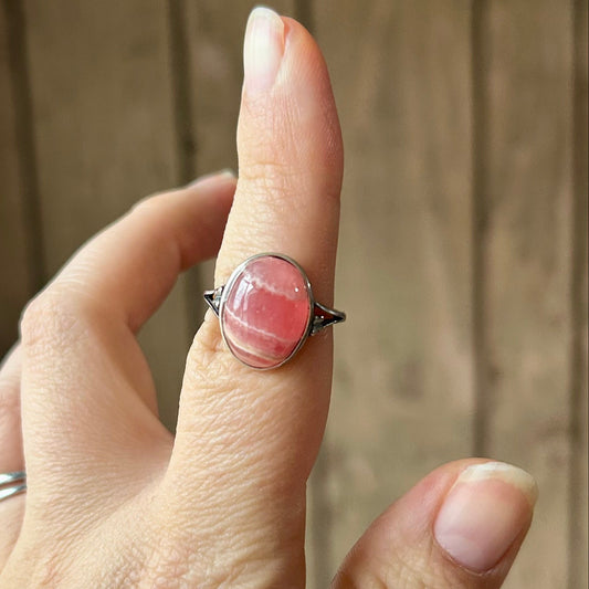 Hand with a ring on a blurred background