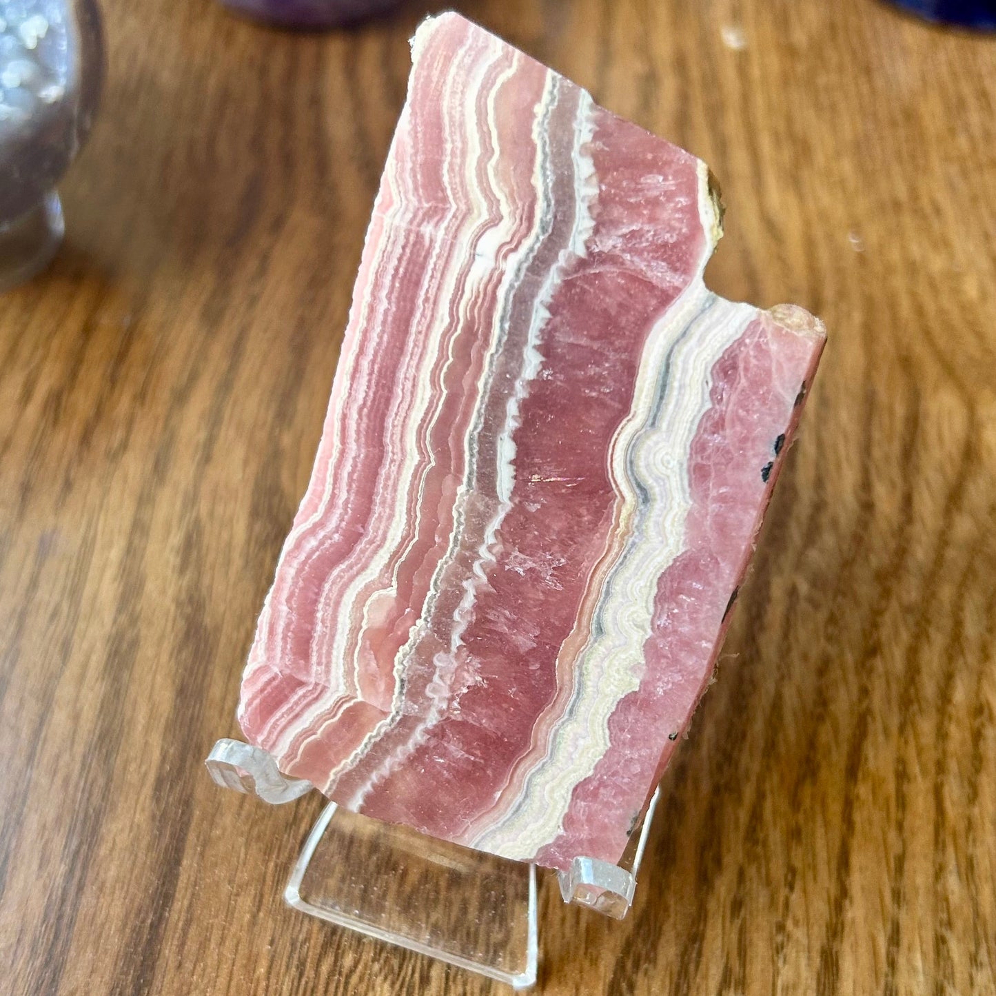 Polished stone slab on a stand with a wooden background
