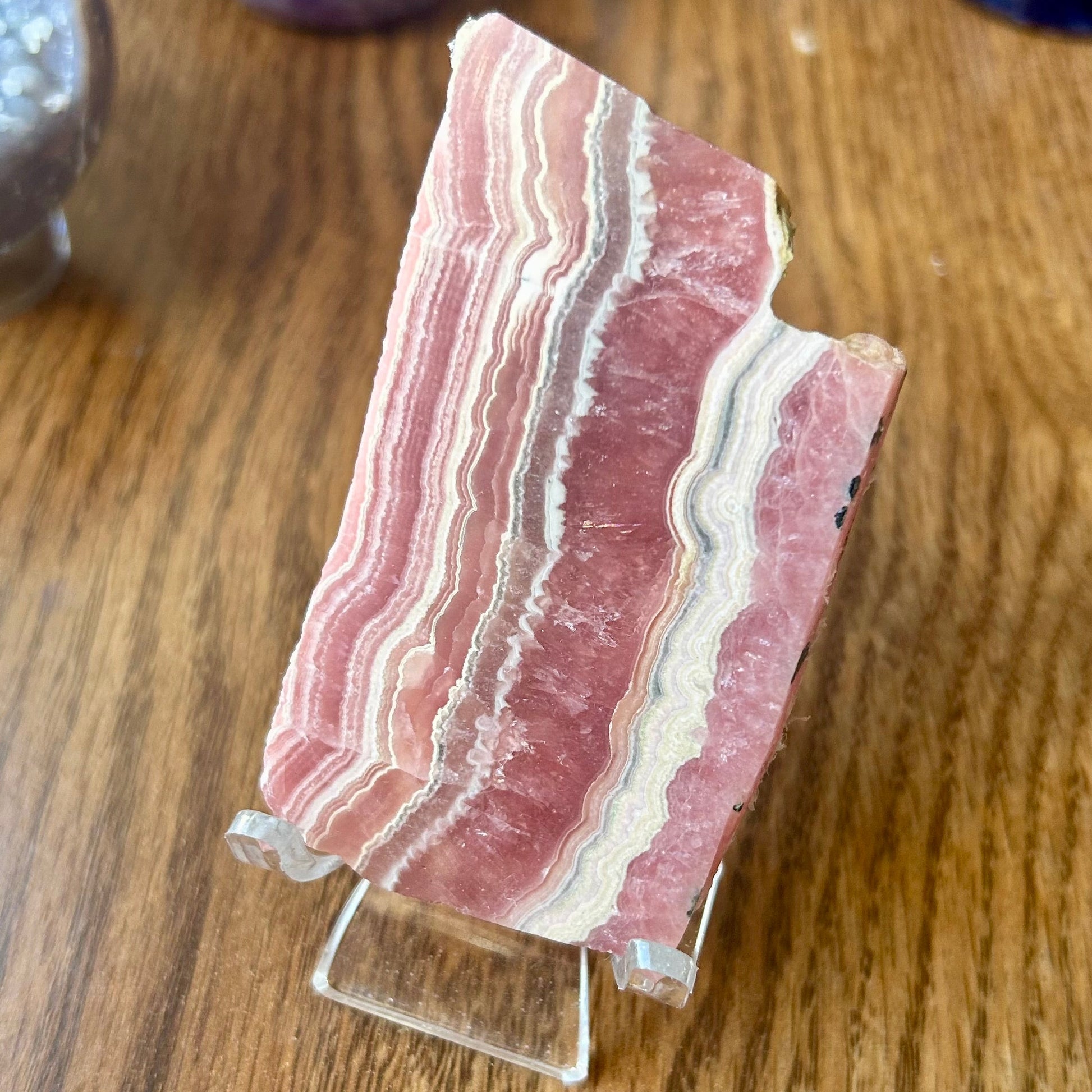 Polished stone slab on a stand with a wooden background
