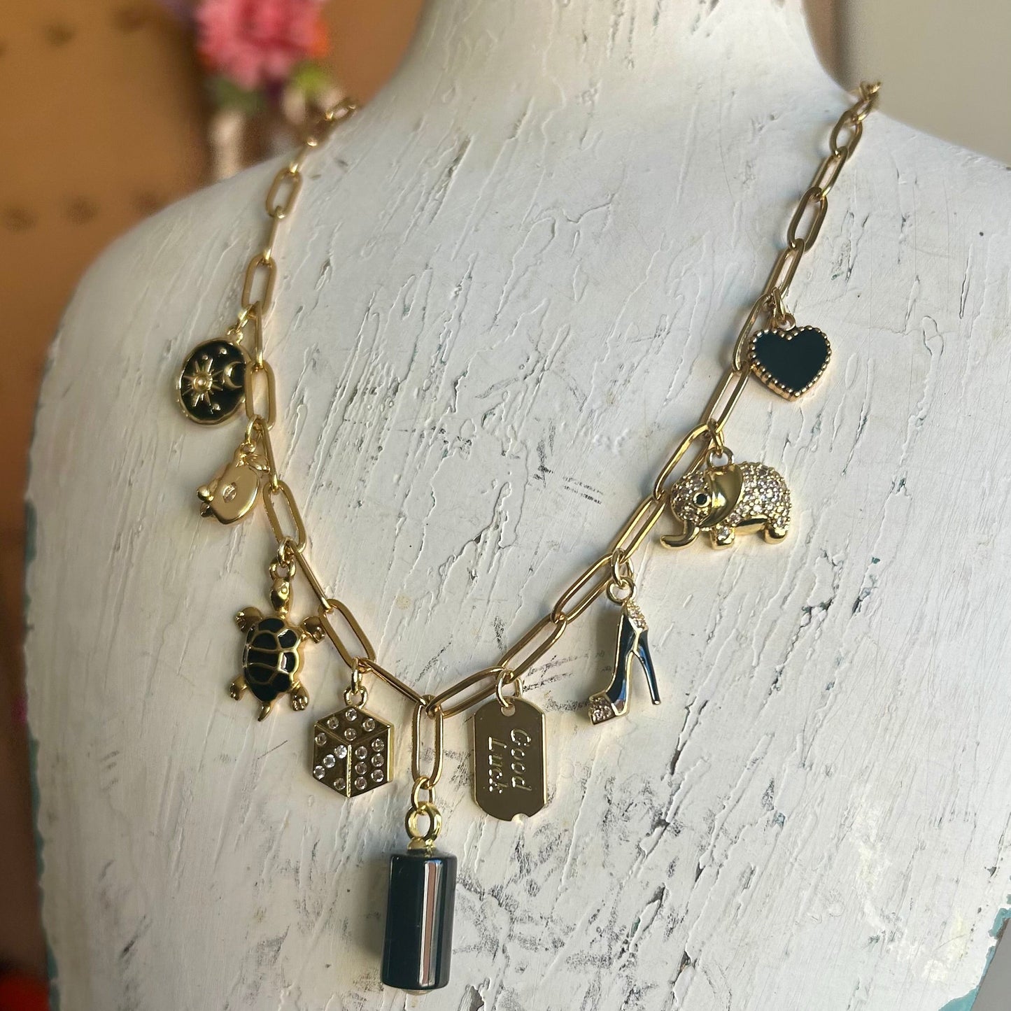 Necklace with various charms on a mannequin bust
