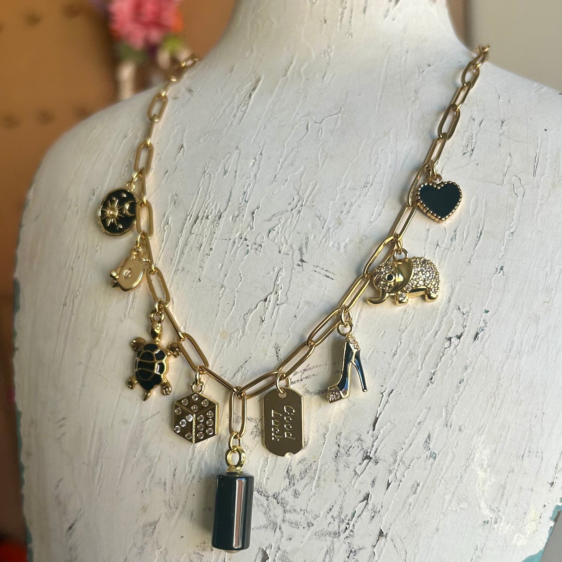 Necklace with various charms on a mannequin bust