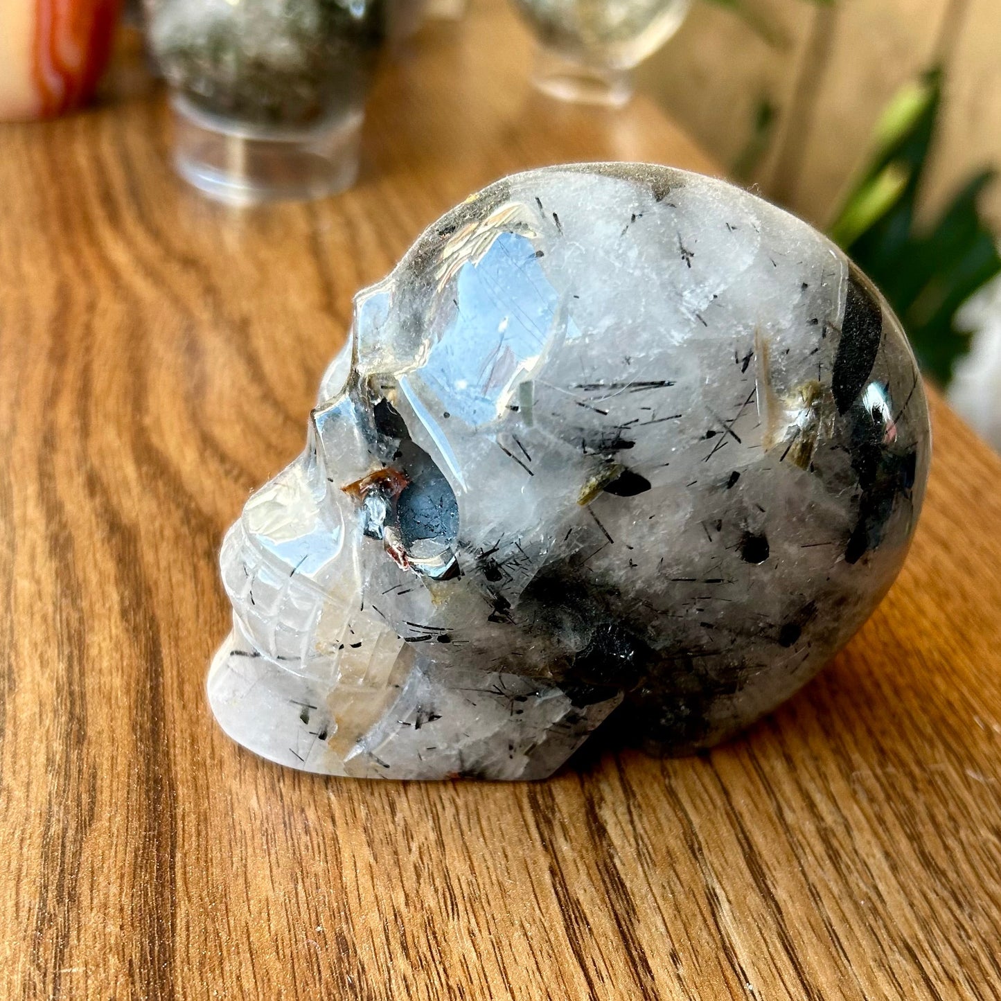 Crystal skull on a wooden surface with blurred background