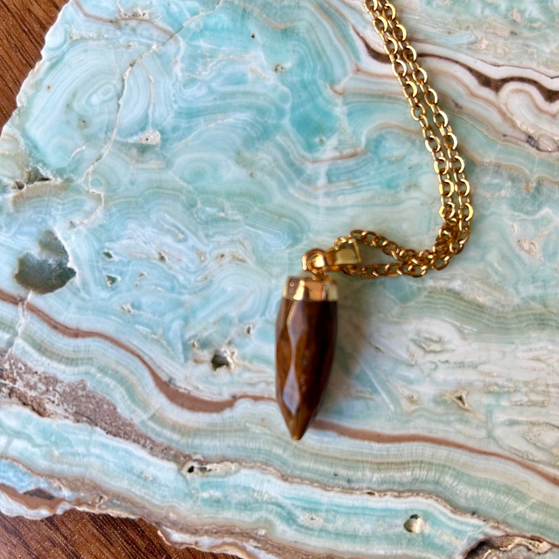 Necklace with a brown pendant on a piece of agate stone