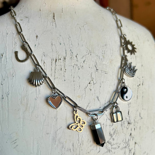 Necklace with various charms on a mannequin bust