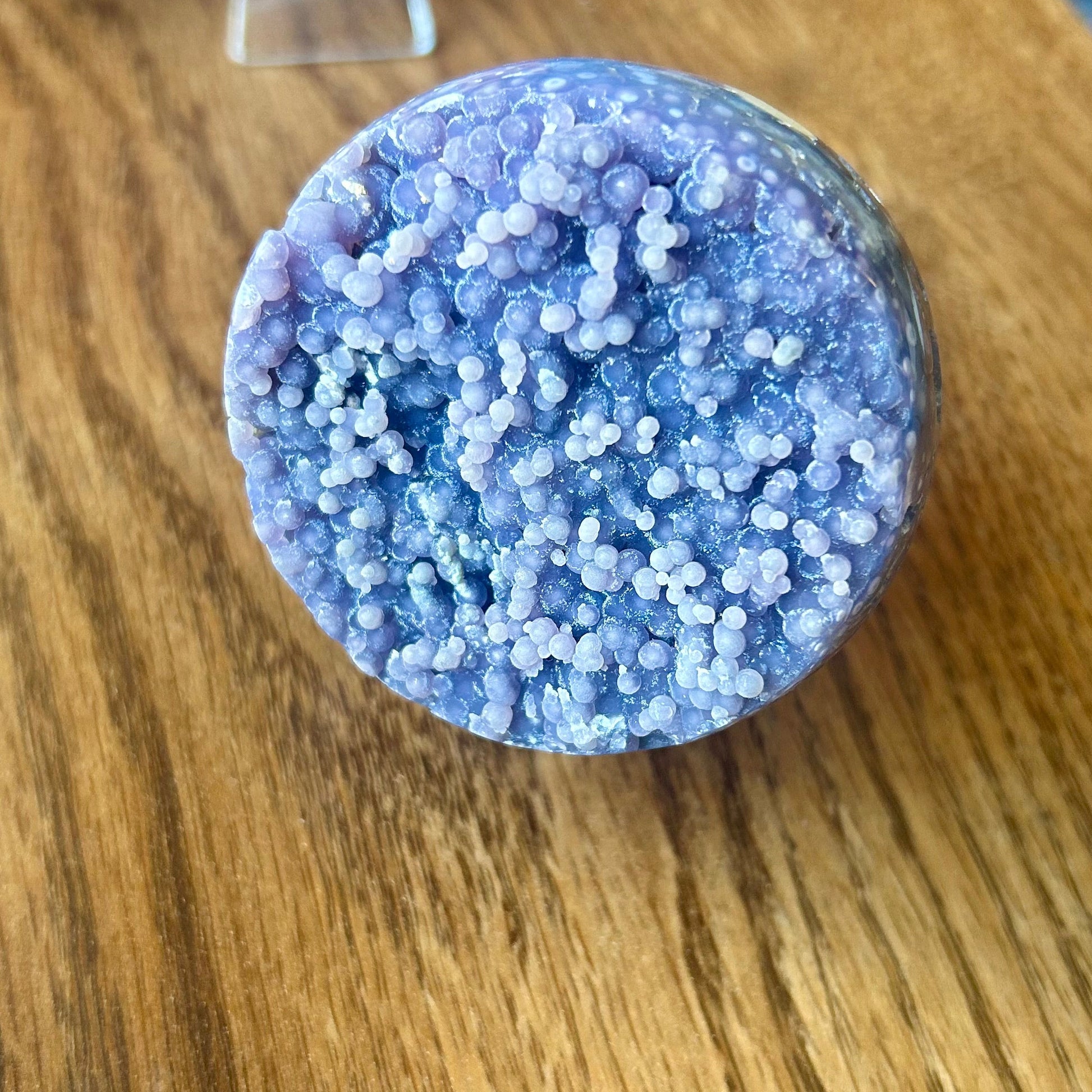 Round blue crystal on a wooden surface