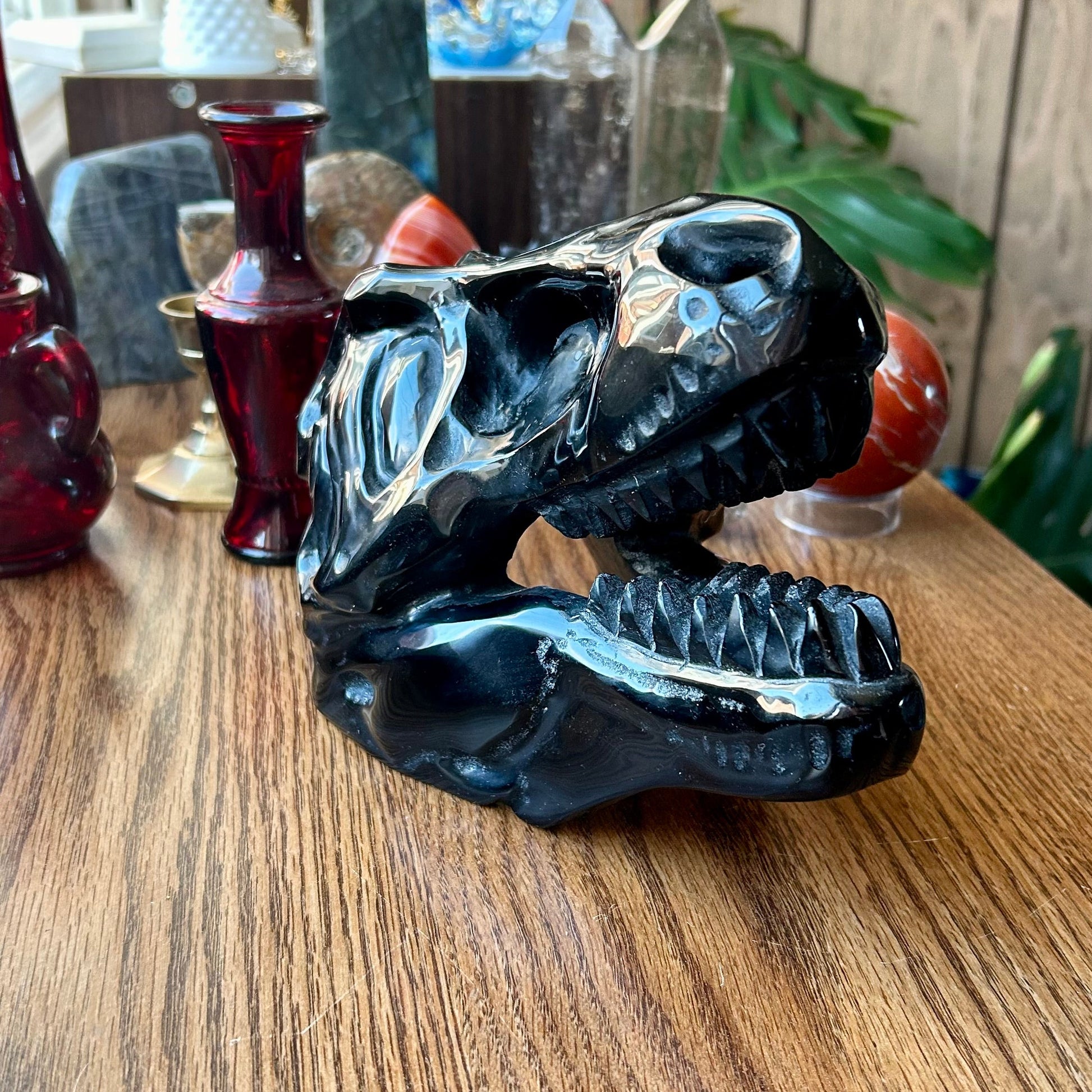 Black and silver dragon sculpture on a wooden surface with blurred background