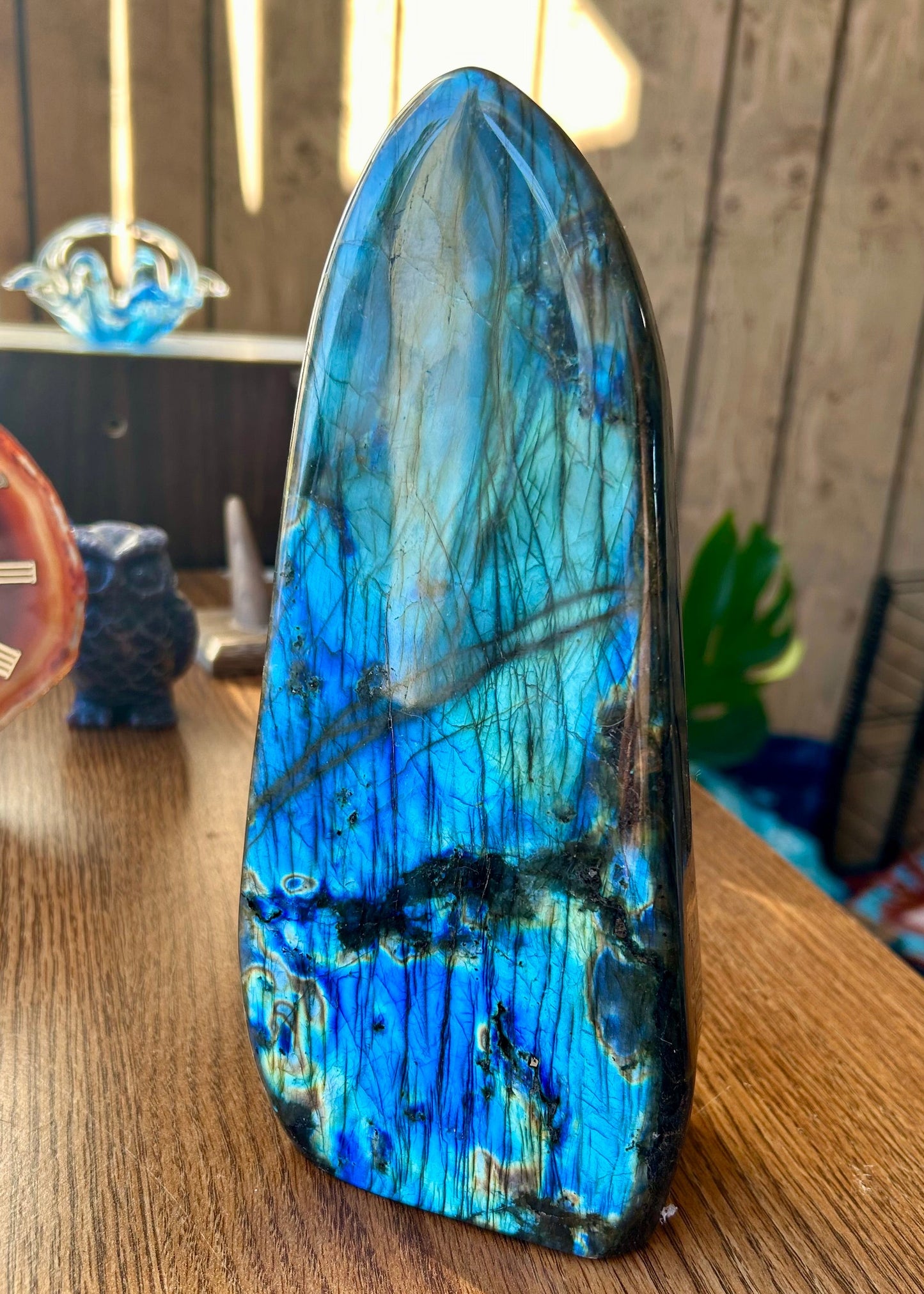 Blue and green crystal on a wooden surface with blurred background