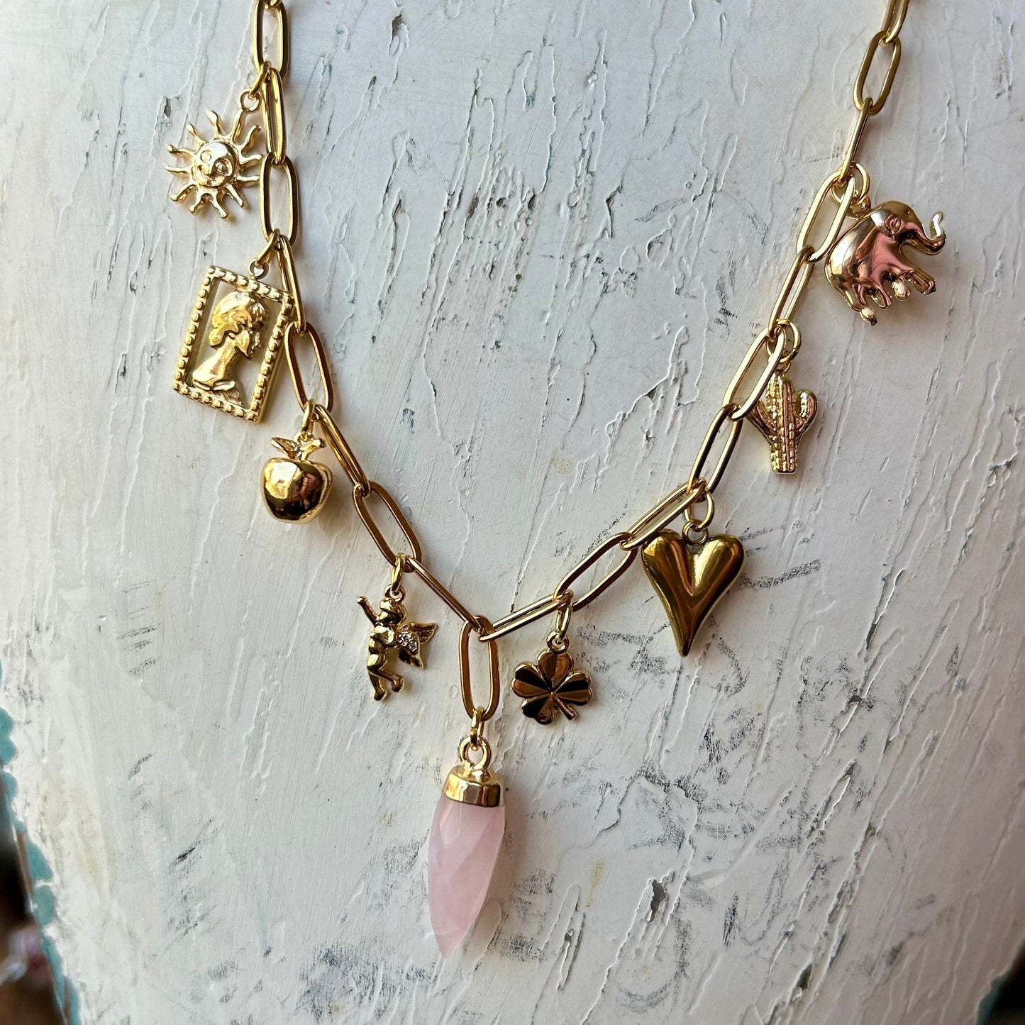 Necklace with various charms on a mannequin bust