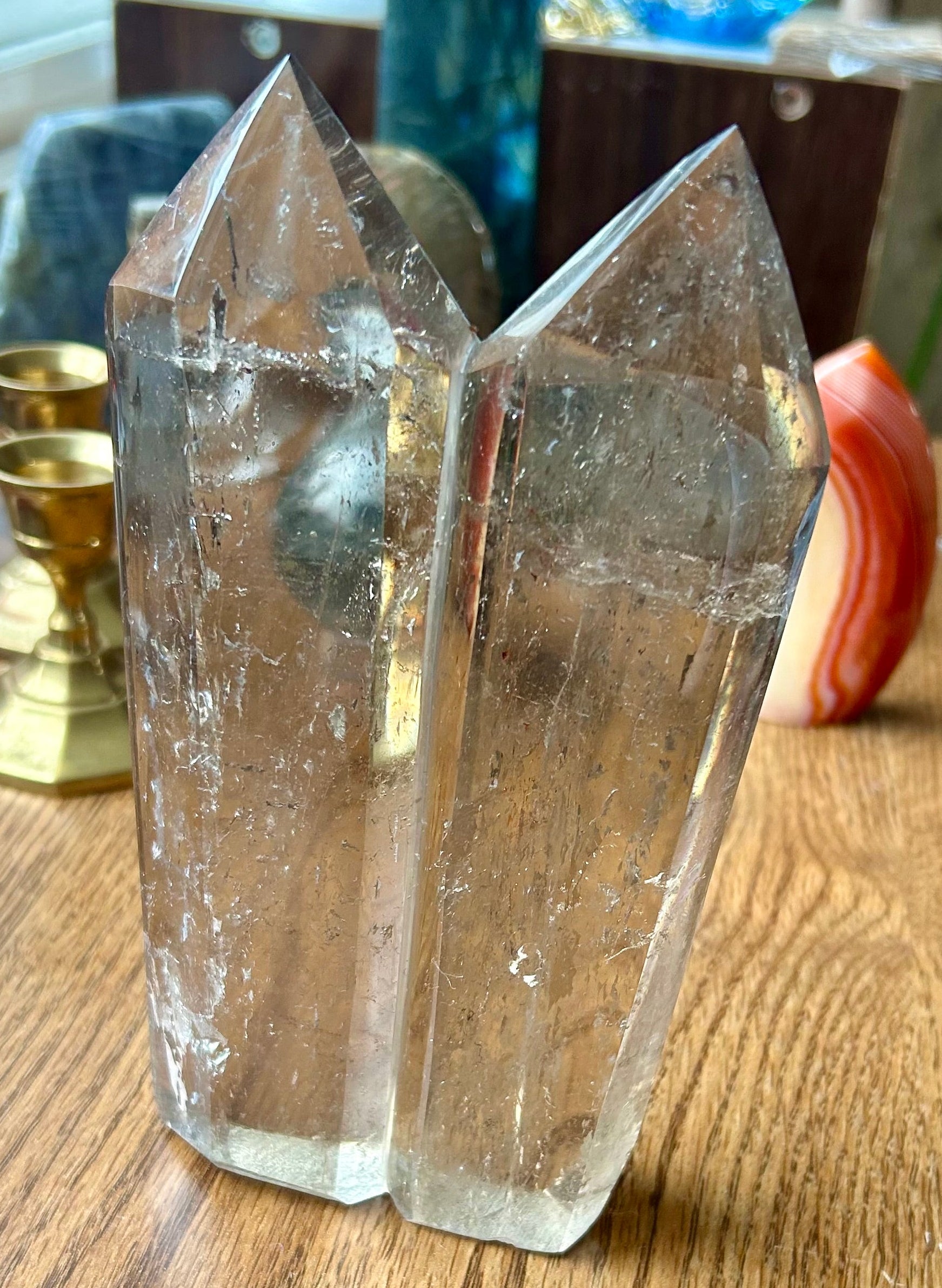 Clear crystal on a wooden surface with blurred background