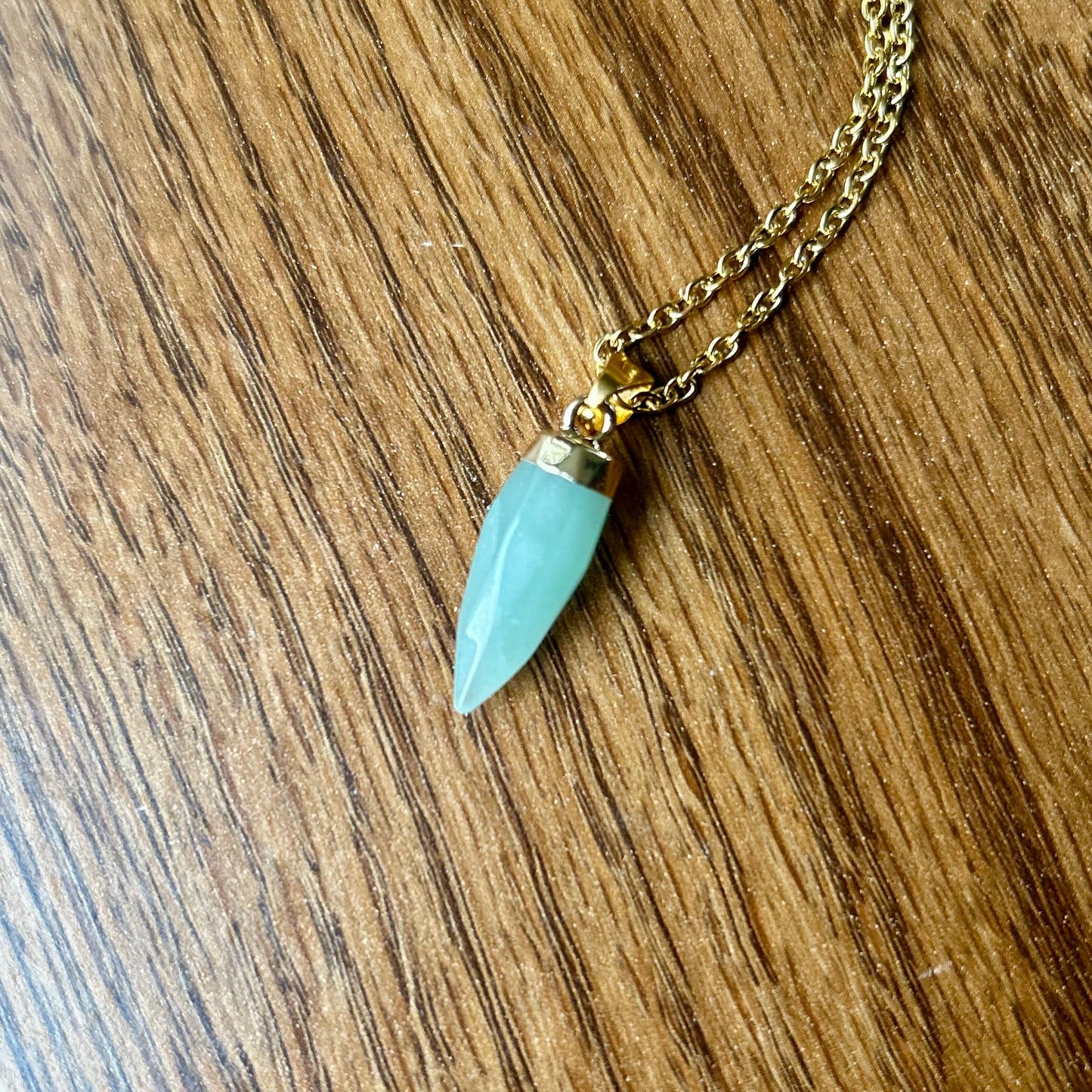 Necklace with a turquoise pendant on a wooden surface
