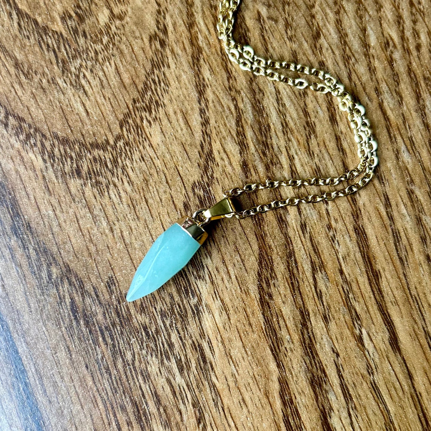 Necklace with a turquoise pendant on a wooden surface