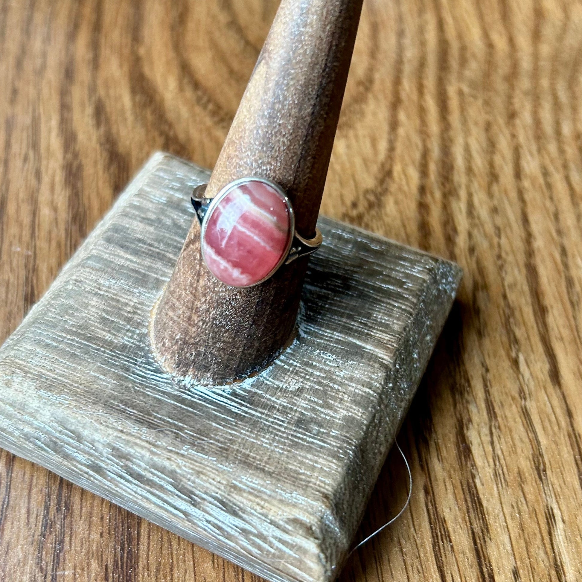 Ring on a wooden stand with a wooden background