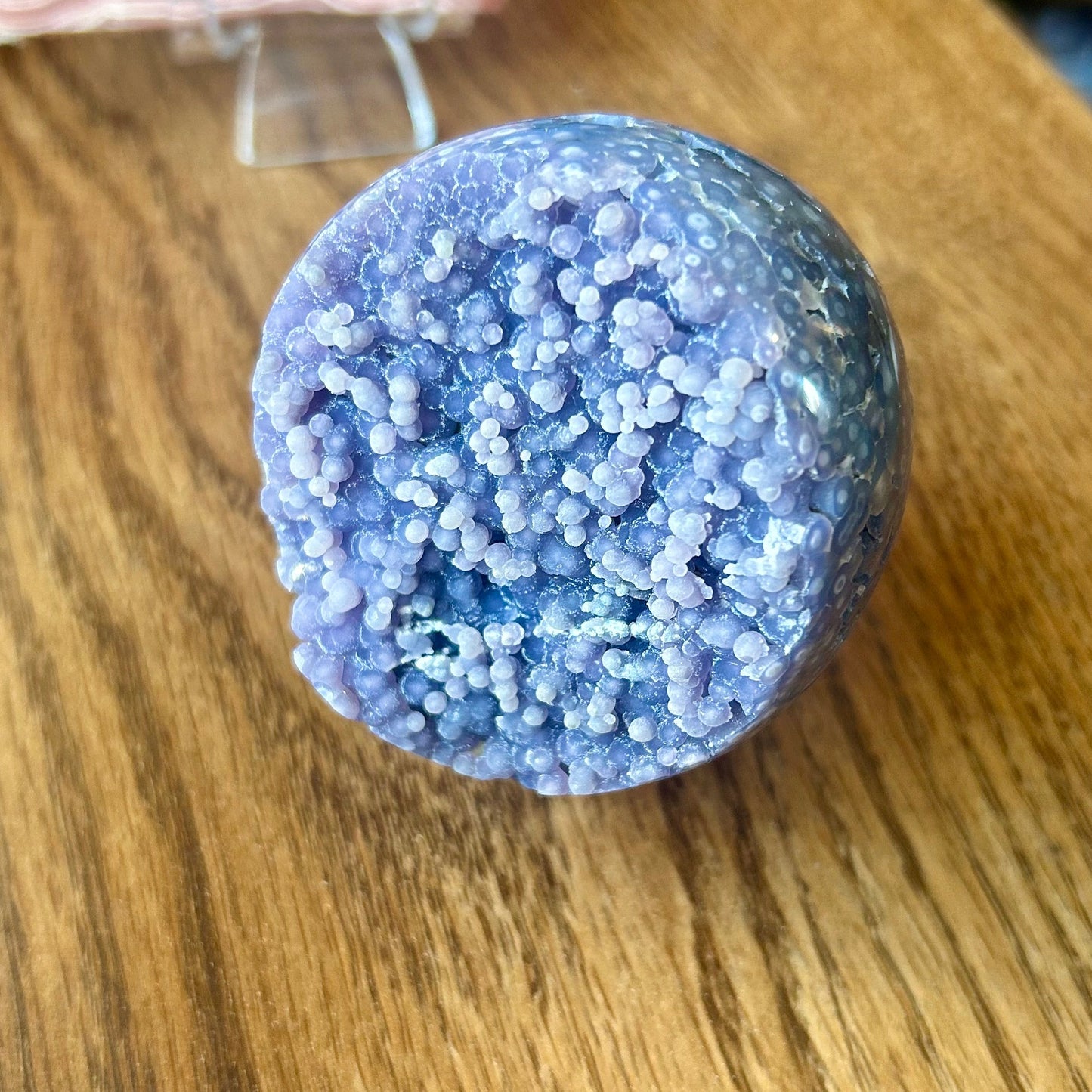 Purple textured ball on a wooden surface