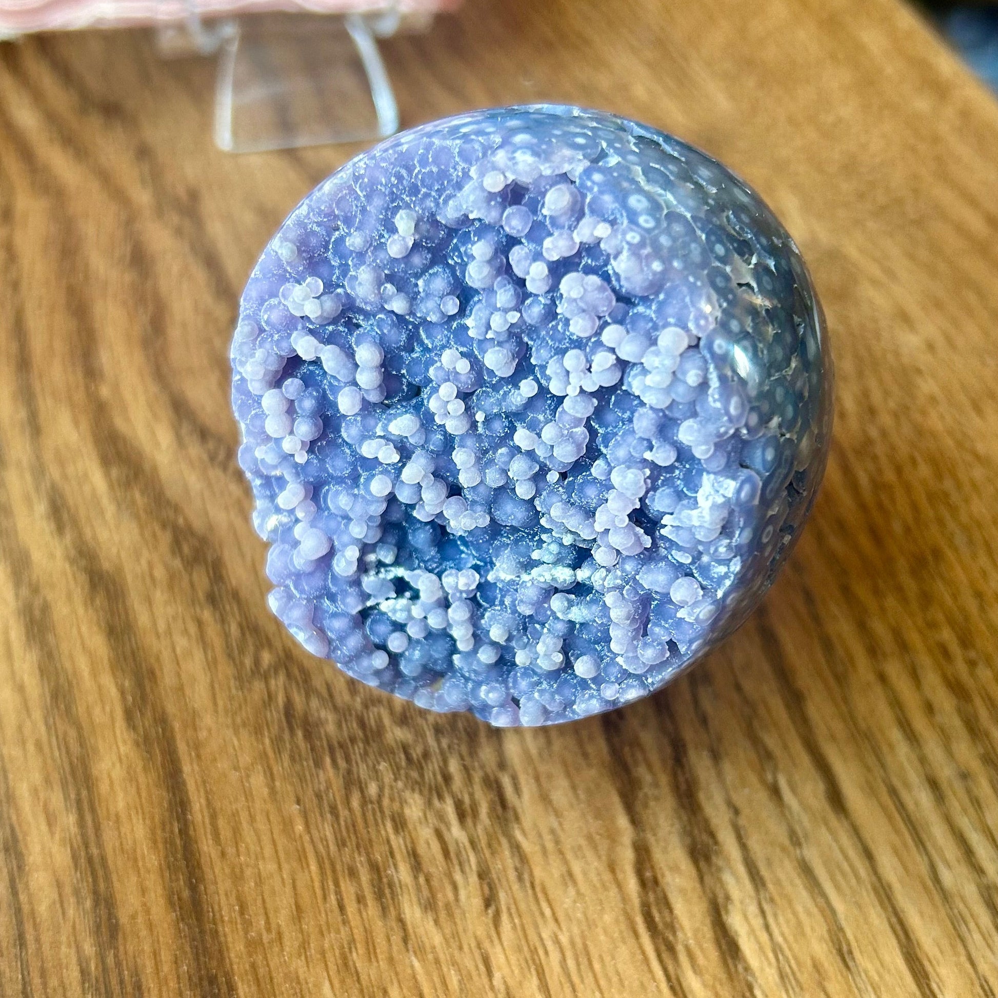 Purple textured ball on a wooden surface