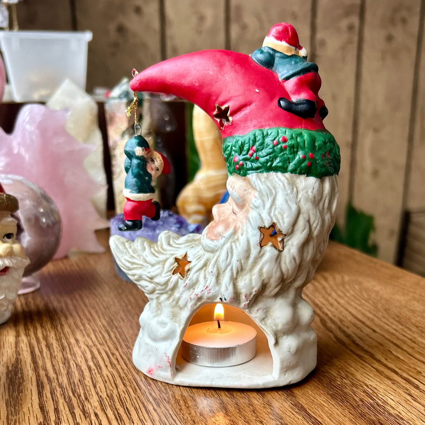 Decorative gnome candle holder on a wooden surface with a wooden background