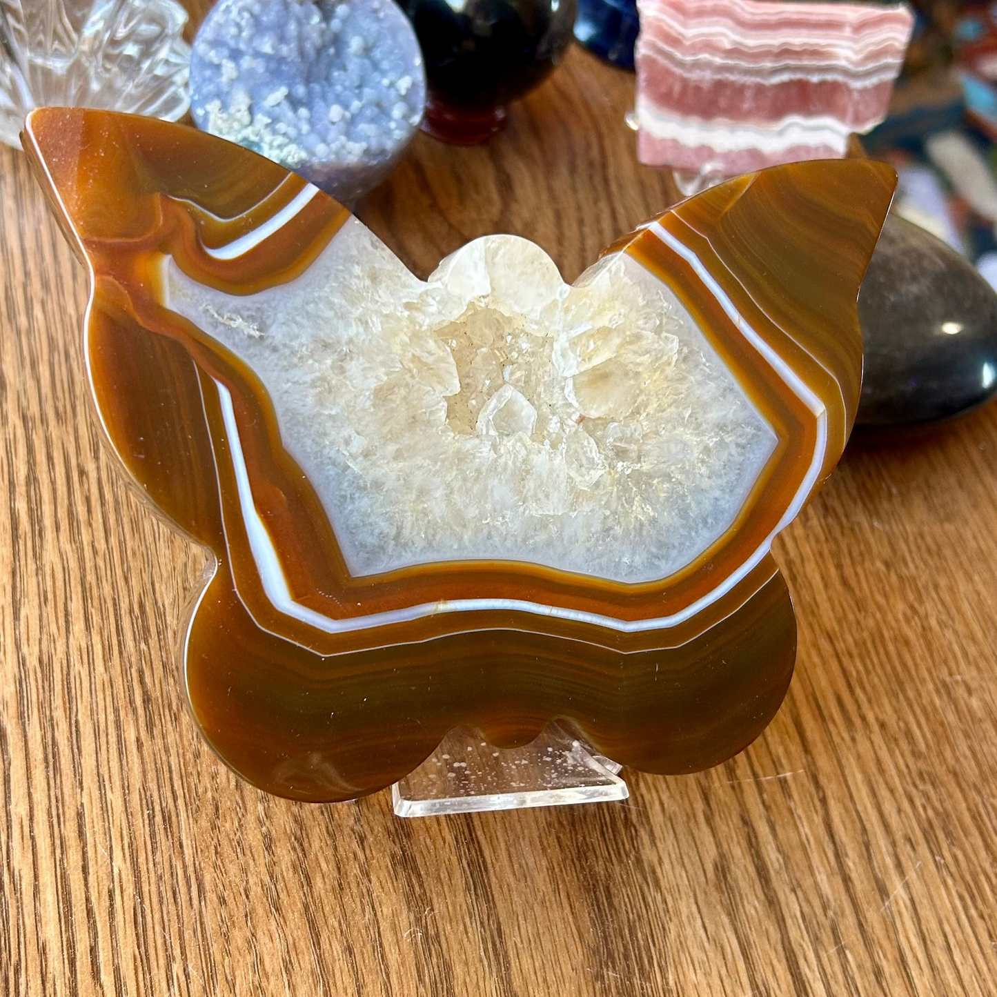 Crystal geode on a stand with other crystals in the background